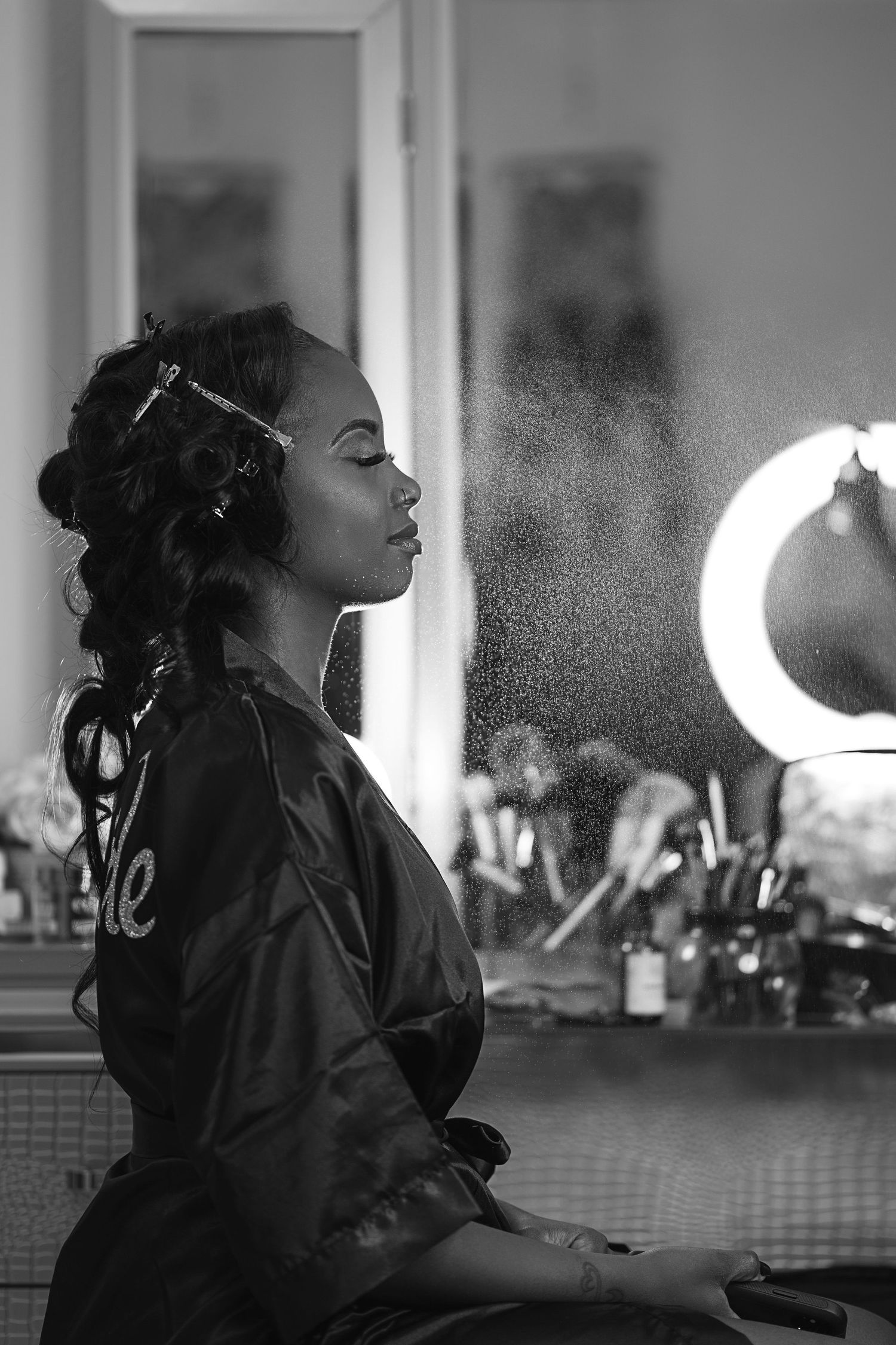 Black and white profile silhouette with dramatic window lighting.