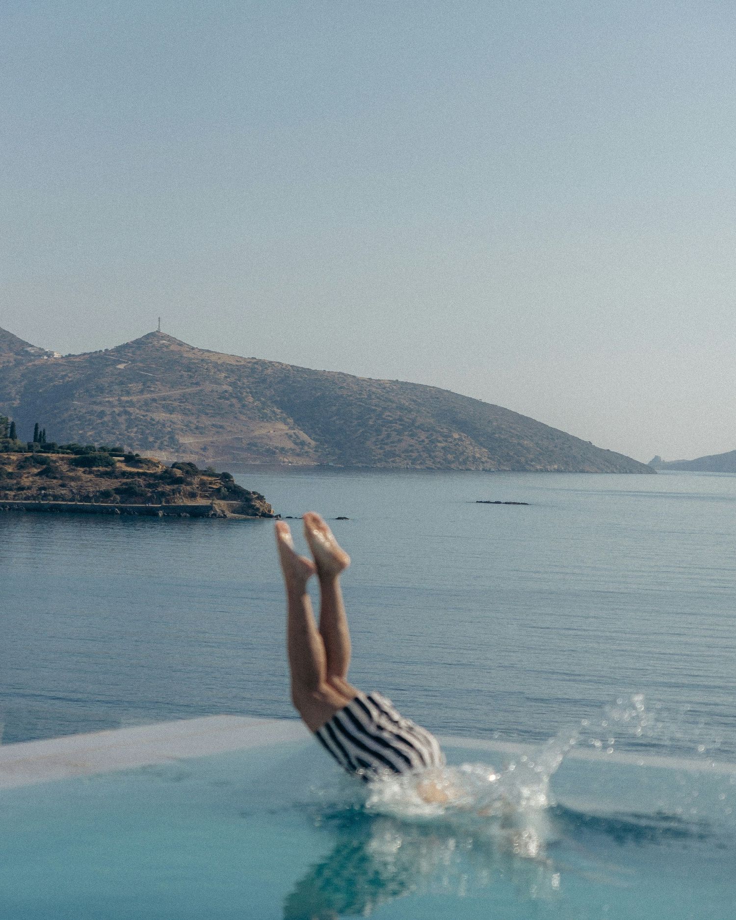 A sequence of photos showing feet splashing into turquoise Mediterranean waters with mountains in the background.
