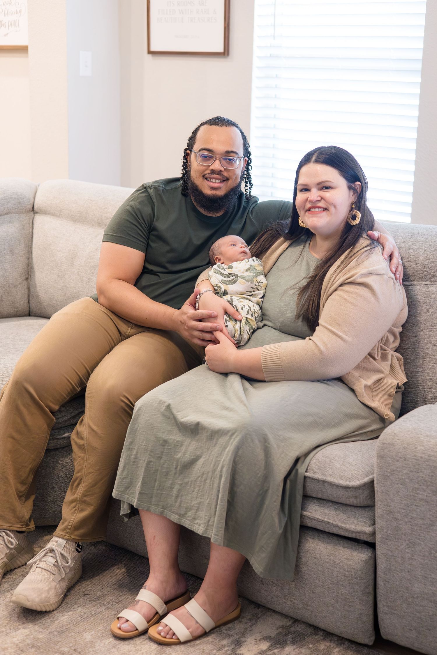Mom and dad hold newborn during baby during in home lifestyle newborn session with McKinney Photographer Reagan Marie photography