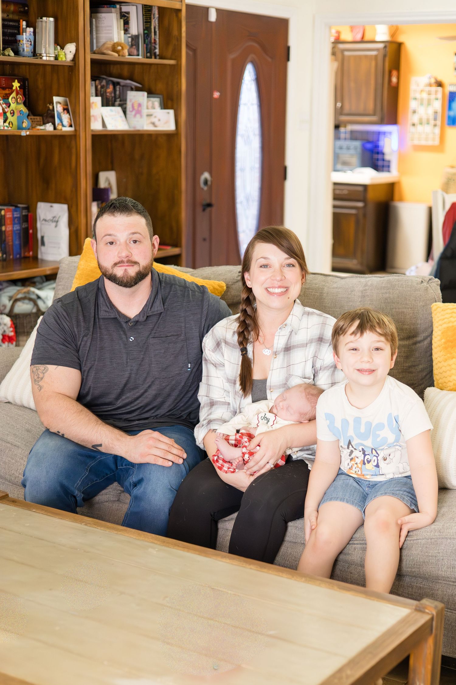 Family poses during in home lifestyle newborn session with Reagan Marie Photography, McKinney based photographer