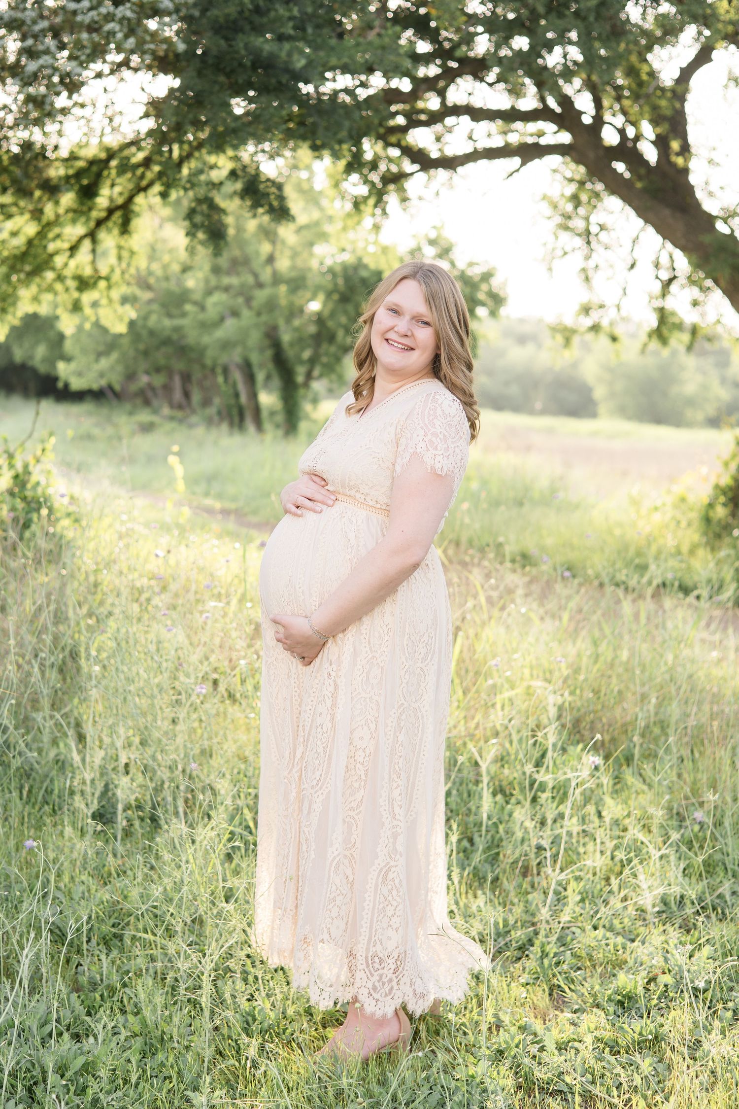 Mom poses during maternity session at Erwin Park in McKinney, TX with mckinney family photographer