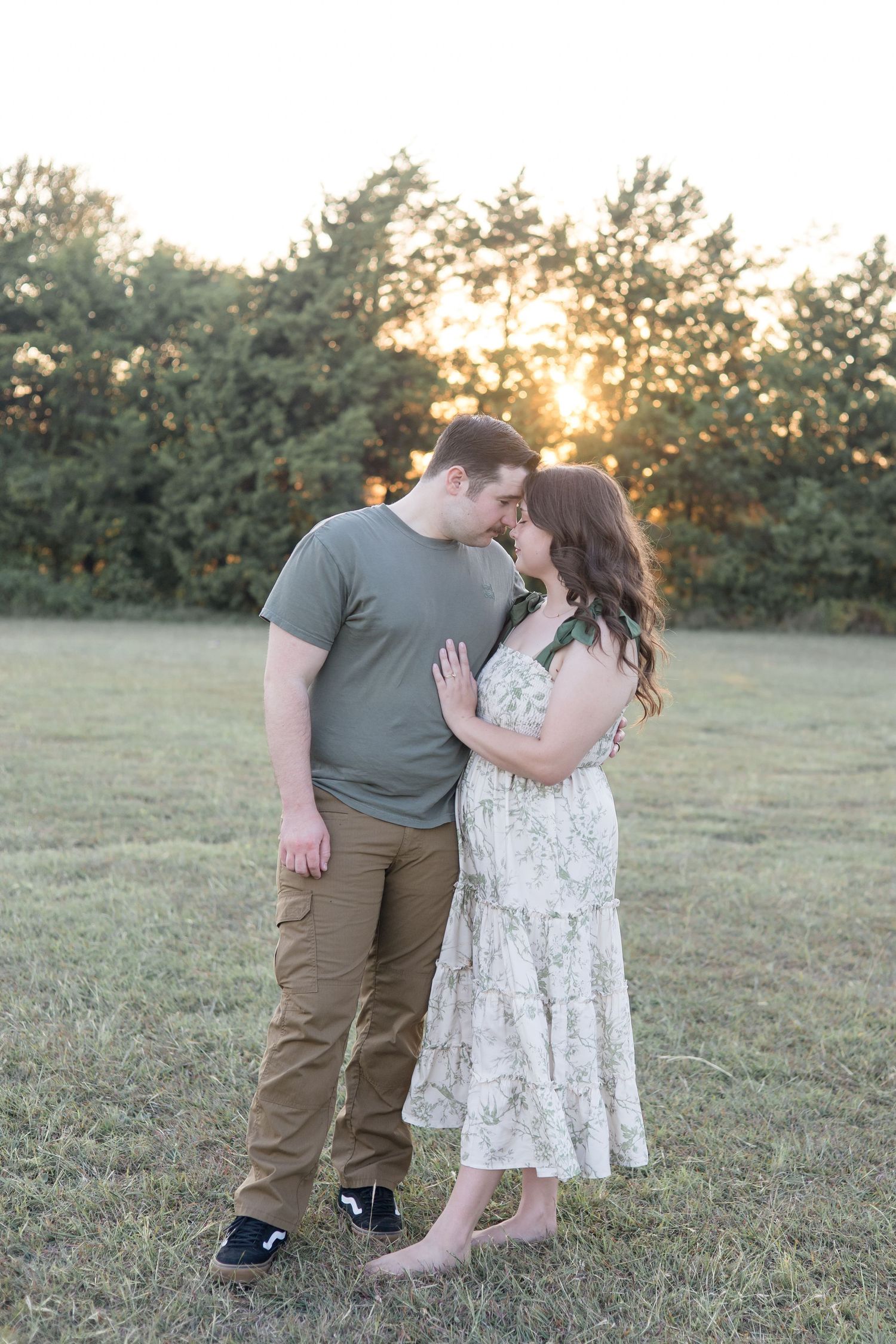 Couple poses in green, tan and white outfits at Erwin Park with McKinney Family Photographer Reagan Marie Photography in the fall
