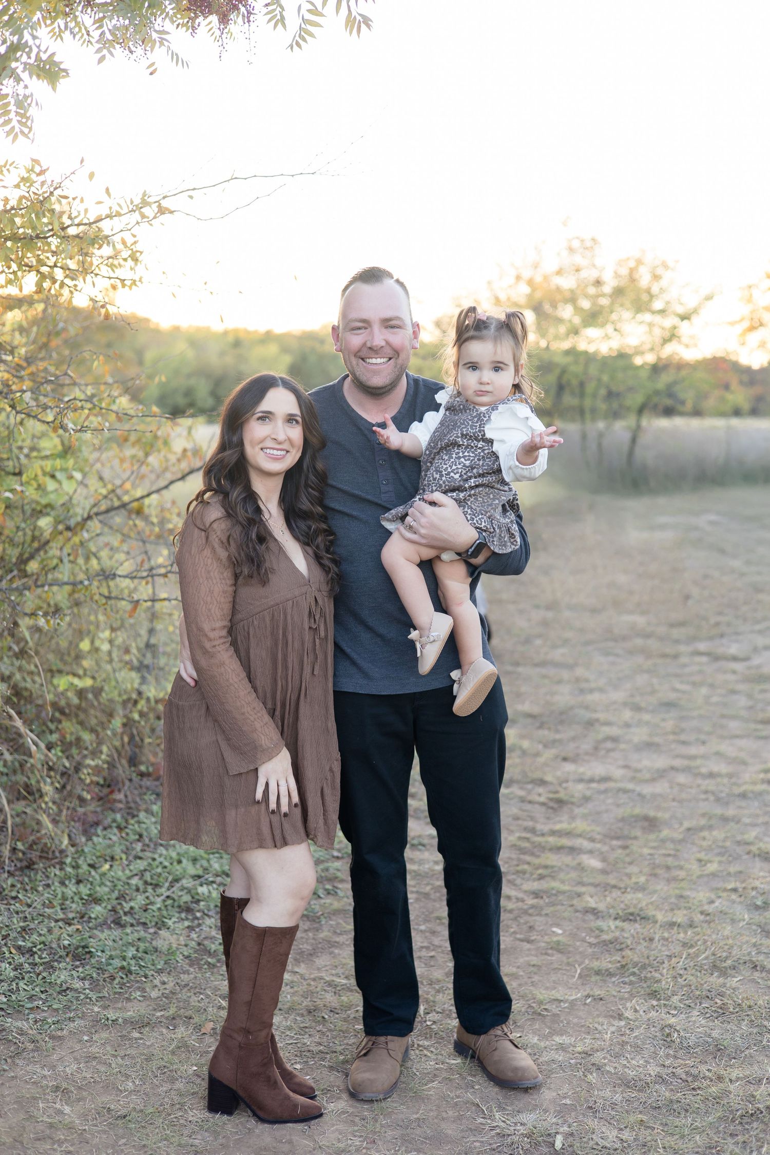 Family poses during golden hour at Frisco Commons Park during fall mini sessions with McKinney Family Photographer