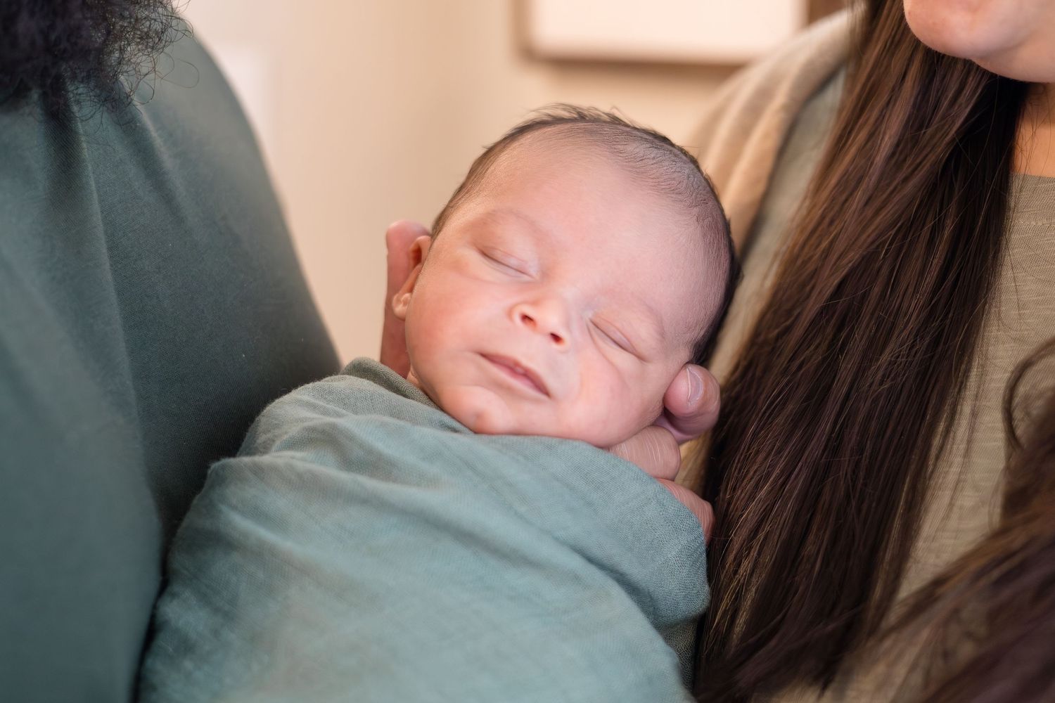 dad holds newborn son during in home lifestyle newborn session with McKinney Photographer Reagan Marie Photography based in McKinney, TX