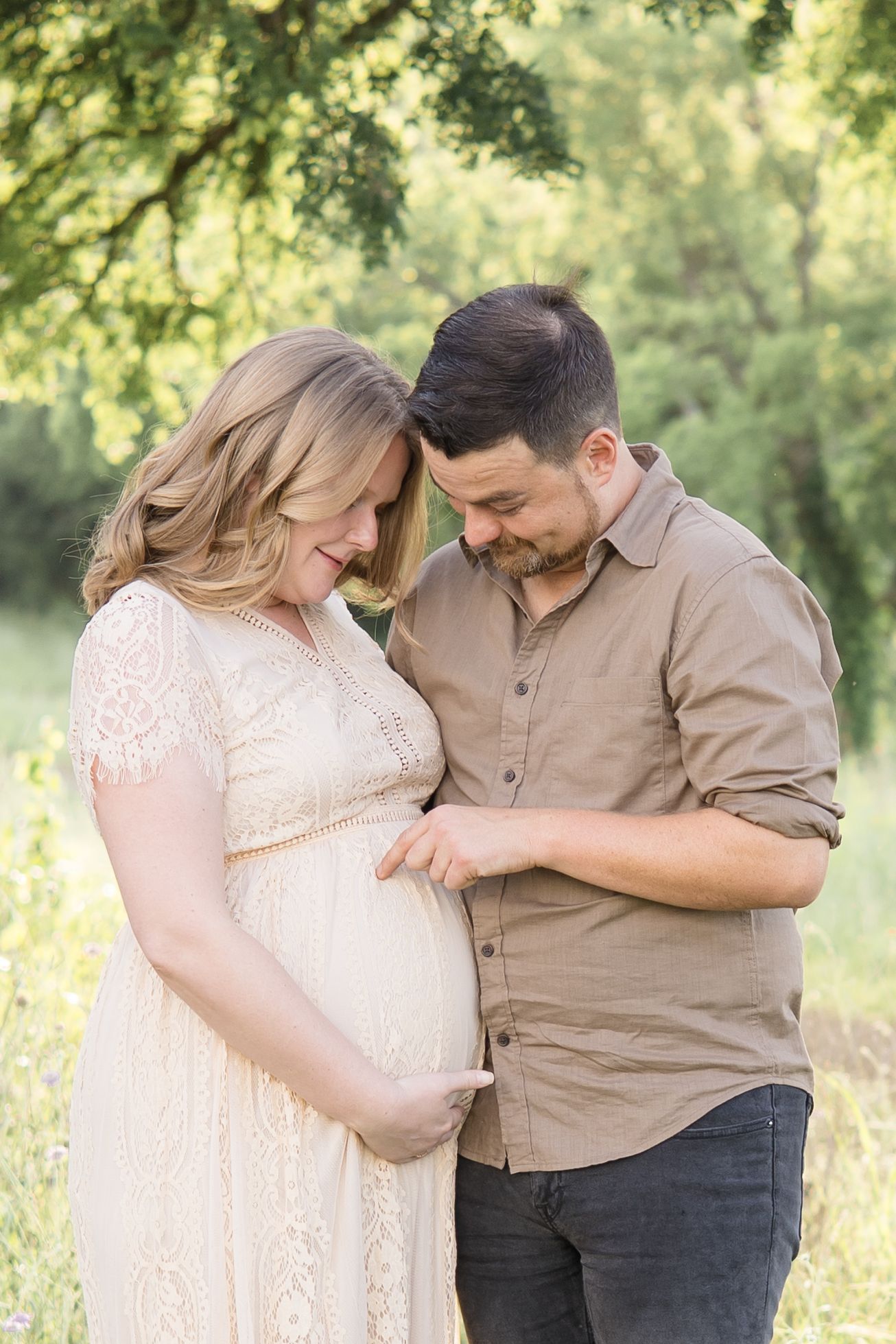 mom and dad pose during golden hour maternity session at erwin park in mckinney texas