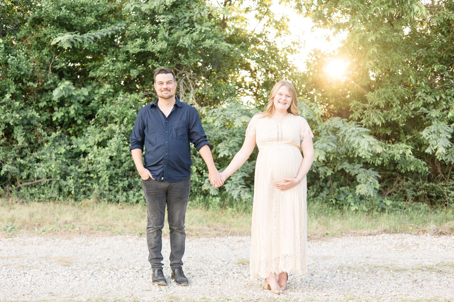 parents pose hand in hand during maternity session at erwin park in mckinney texas with dallas maternity photographer