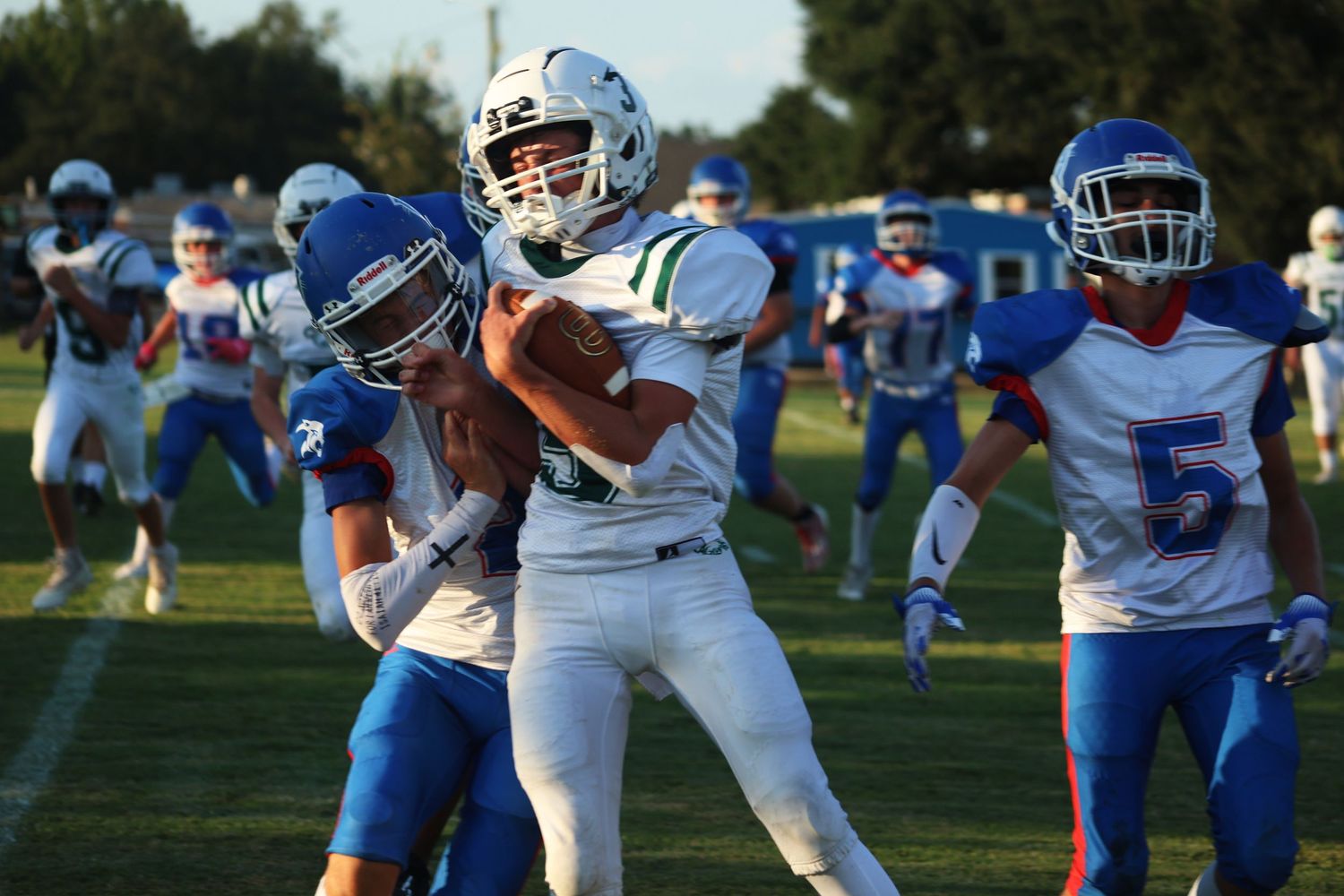 A football player getting tackled by another team