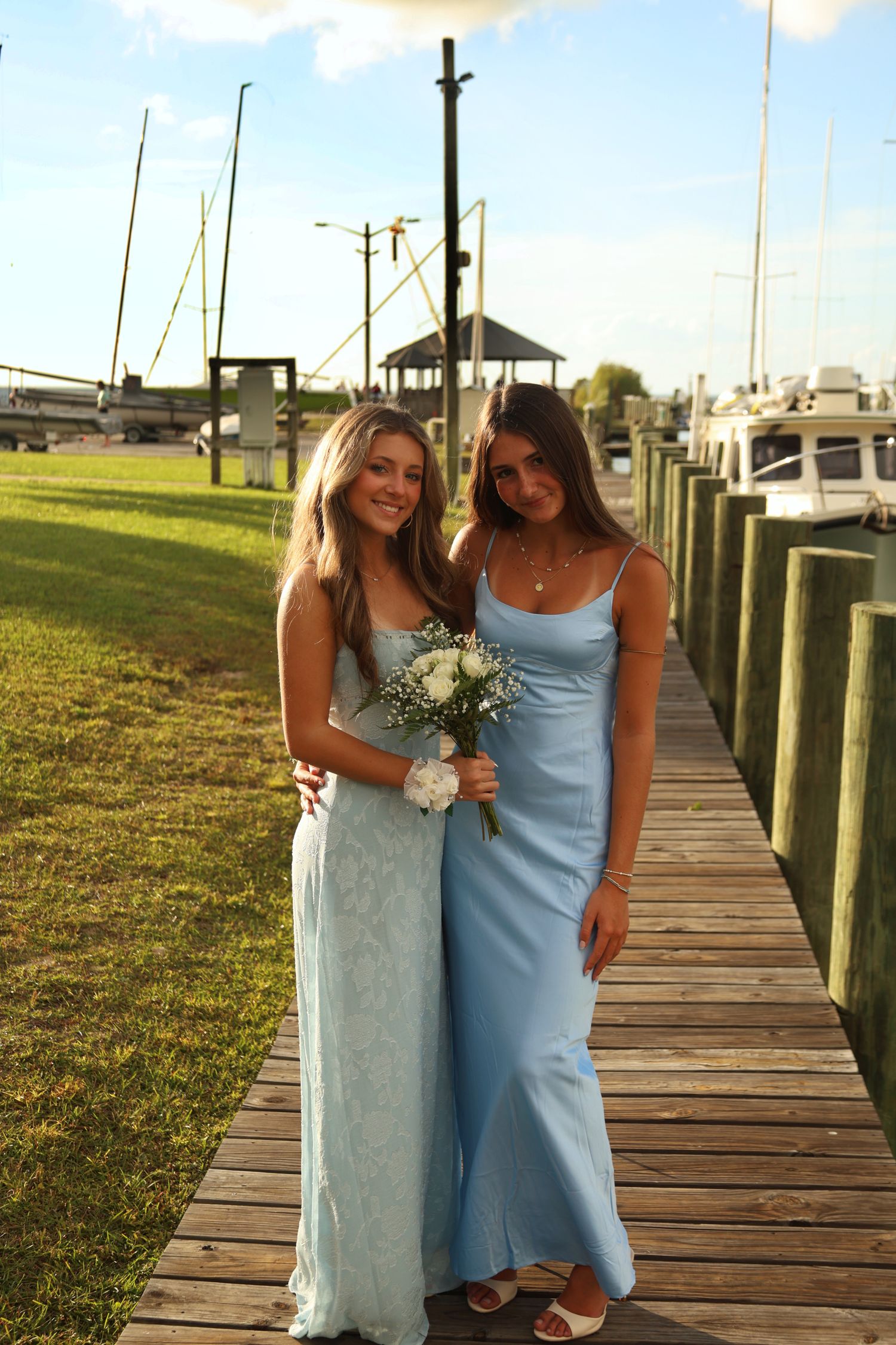 Two girls in dresses with a flower bouquet