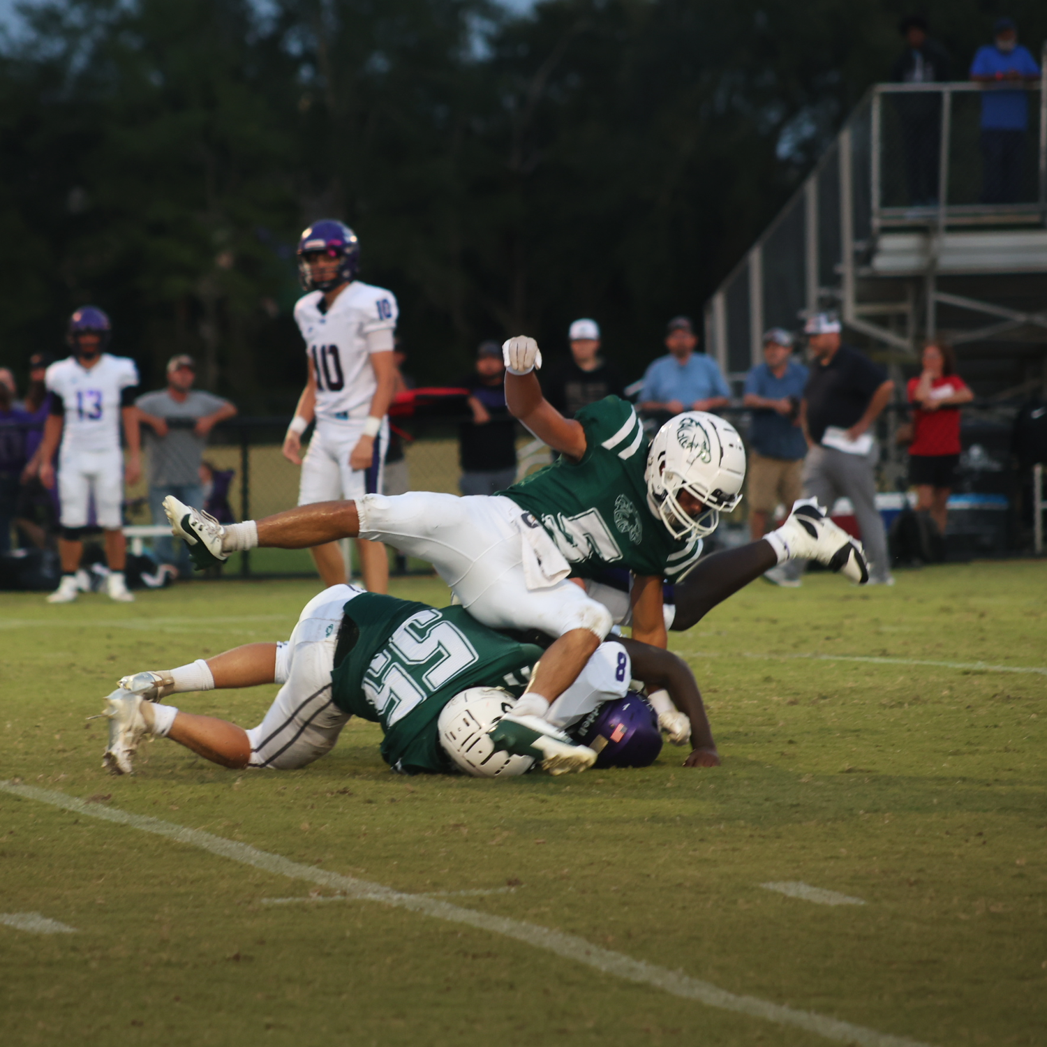 A football player on top of the player with the ball
