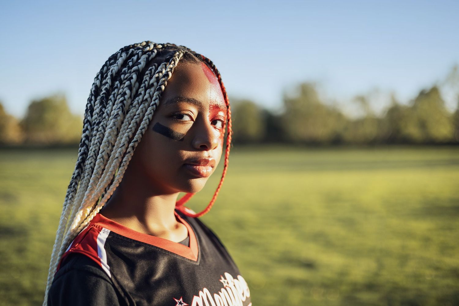 Sunlit outdoor portrait session in golden field during sunset.