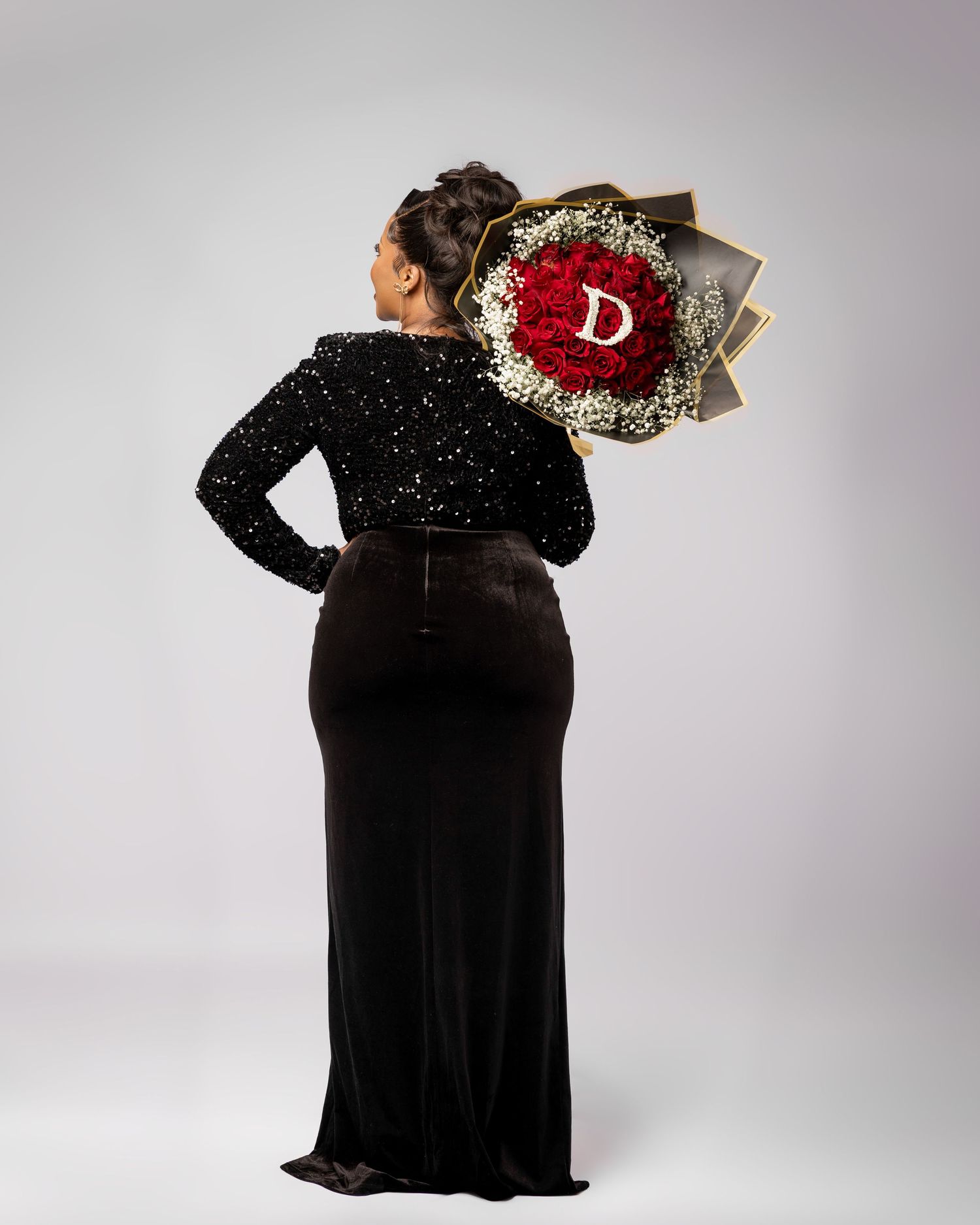 Black sequined evening dress with embellished red and gold designer logo patch displayed from multiple angles.
