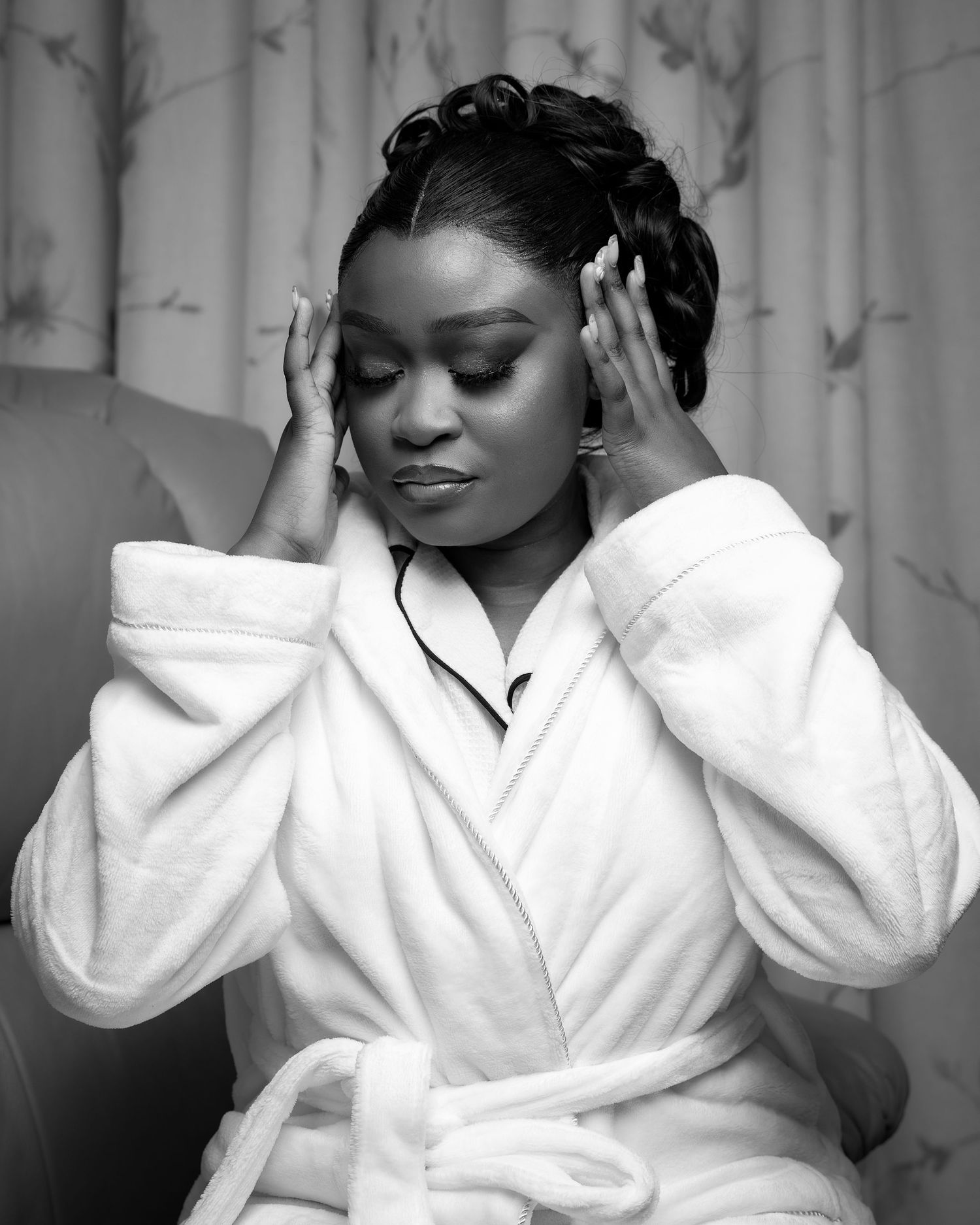 Series of black and white portraits showing person in white bathrobe against curtained background.