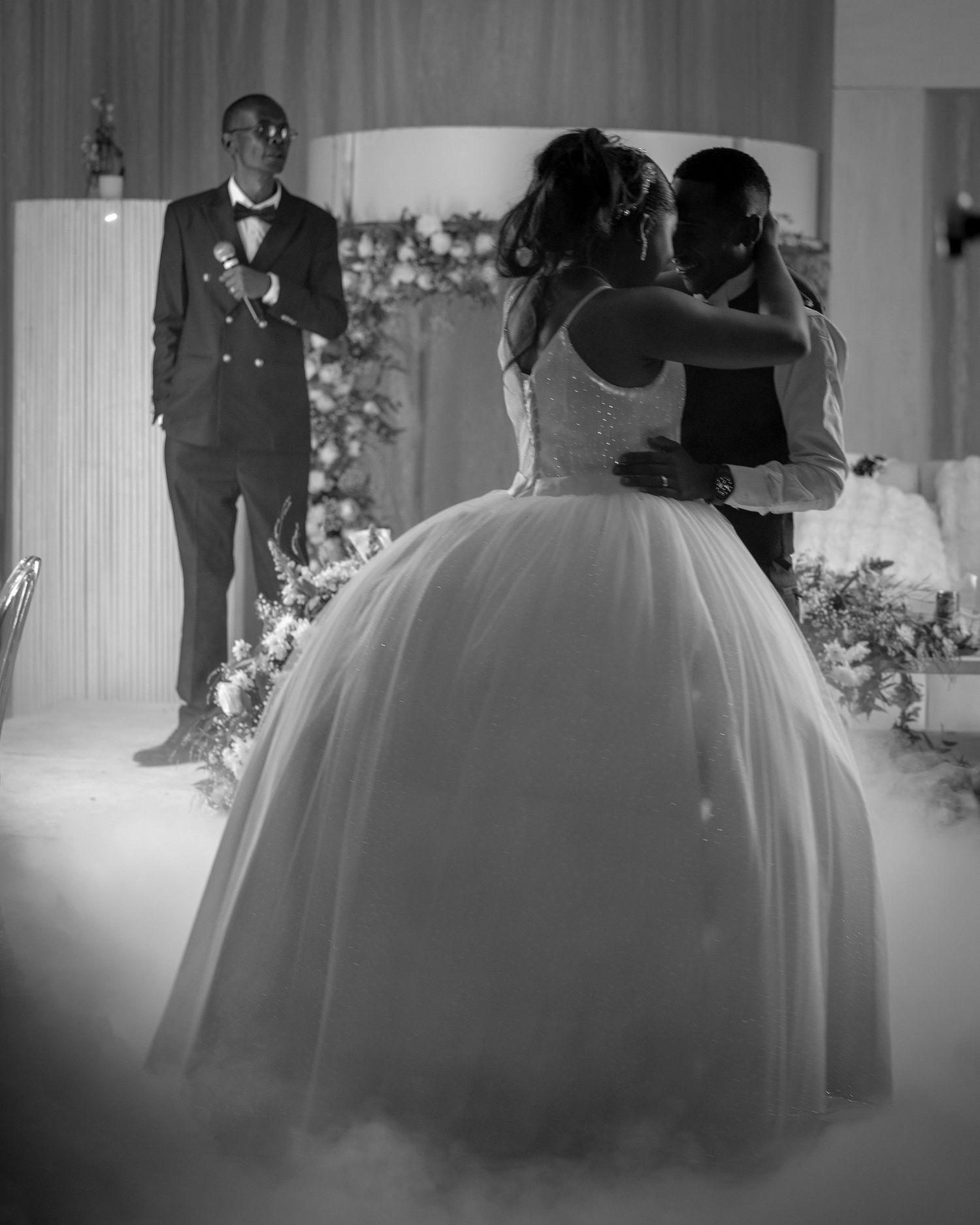 Black and white wedding ceremony photos showing bride in flowing gown.