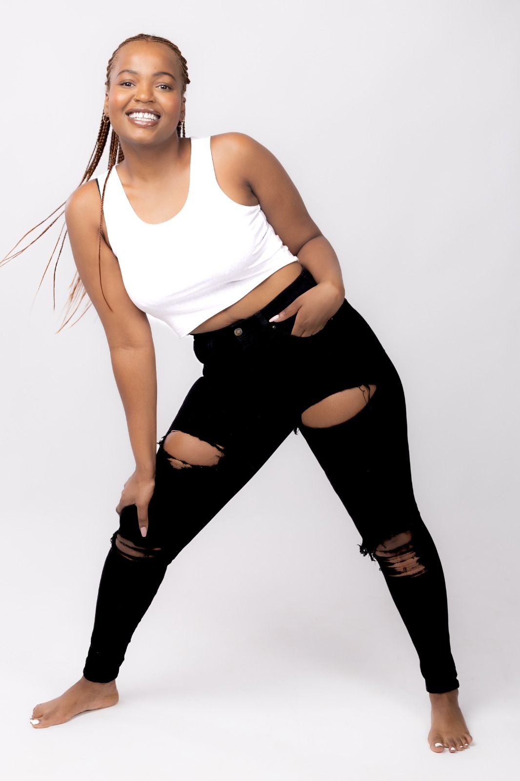 Studio portrait series showing dynamic poses in white tank top and black pants against white background.