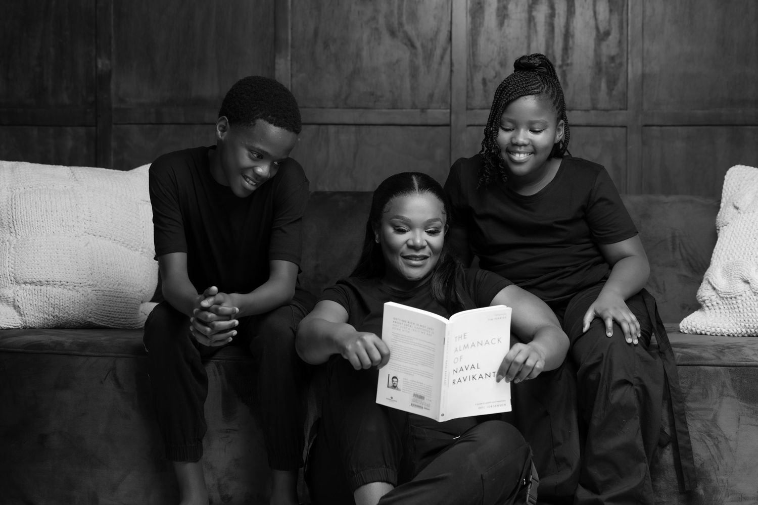 A candid black and white family photo session showing joyful moments and laughter.