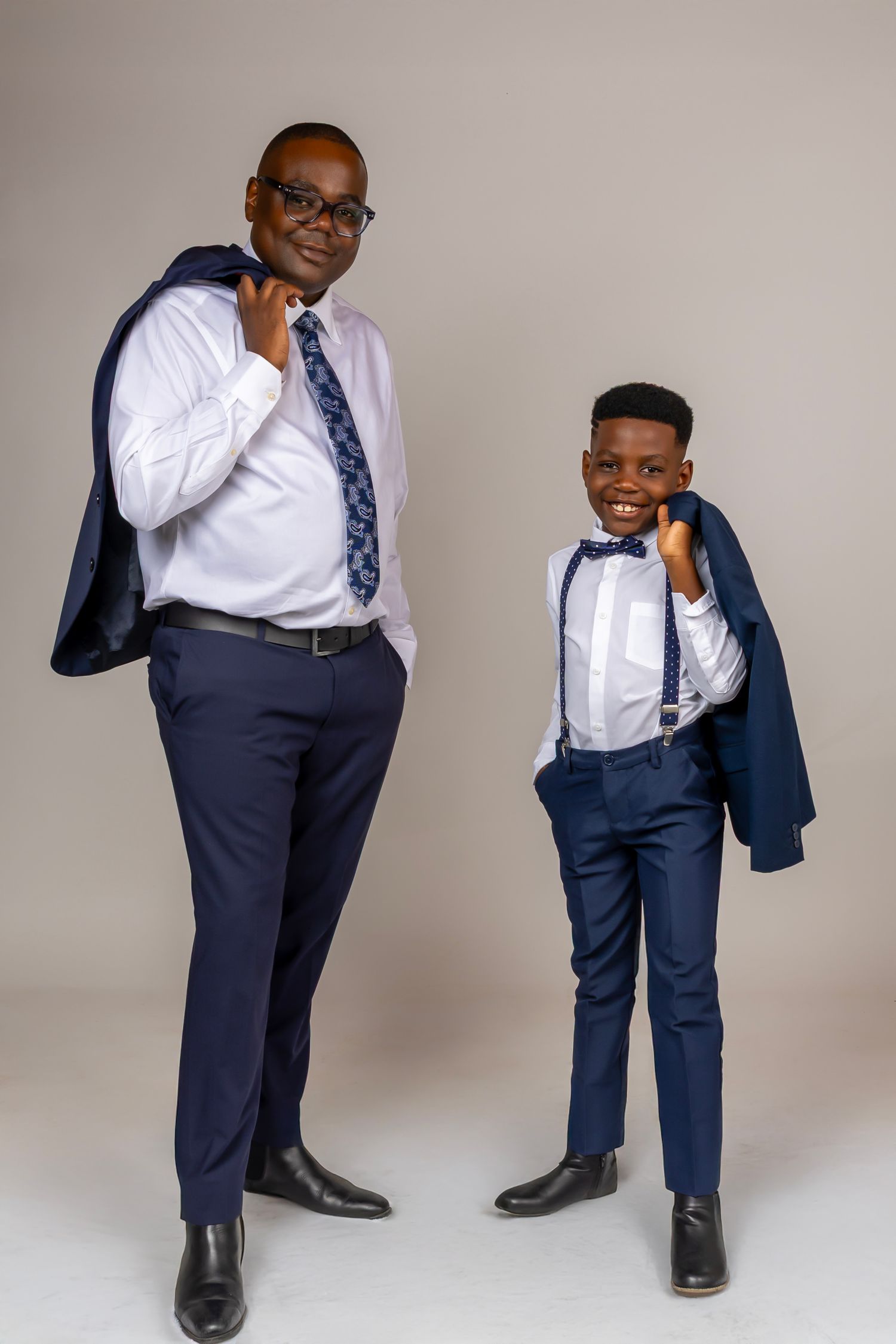 A sequence of photos showing someone in a navy suit and tie striking playful poses against a light gray background.
