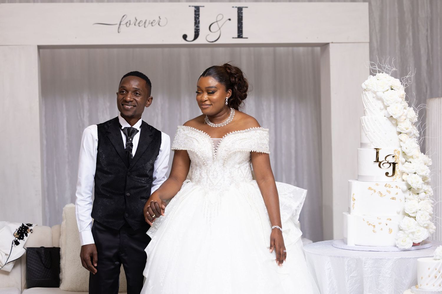 Elegant wedding ceremony setup with white decor and floral arrangements.