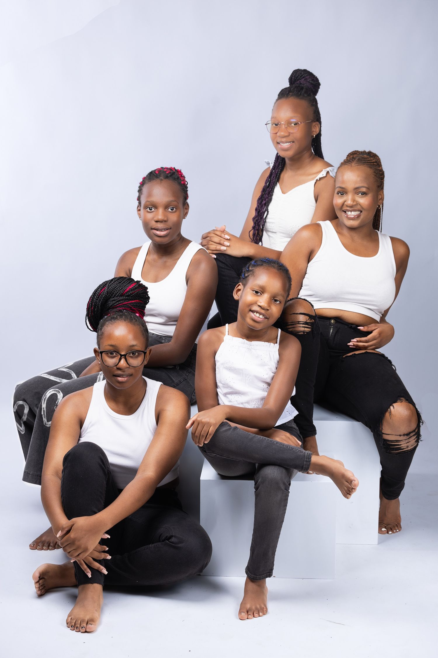 A stylish black and white athletic photoshoot featuring coordinated poses on a light gray background.