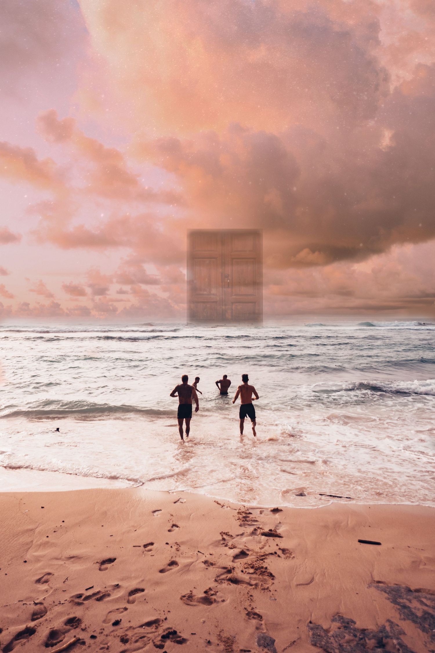Three people running into ocean waves at sunset on a tropical beach with pink cloudy sky.