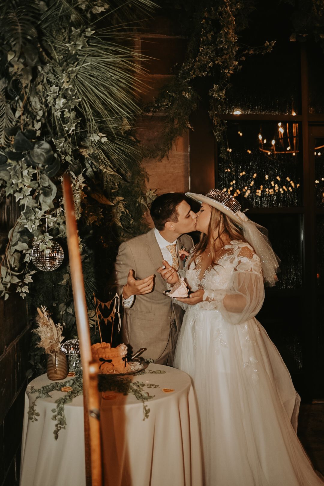 Romantic evening wedding scene with floral arrangements and candlelit atmosphere.