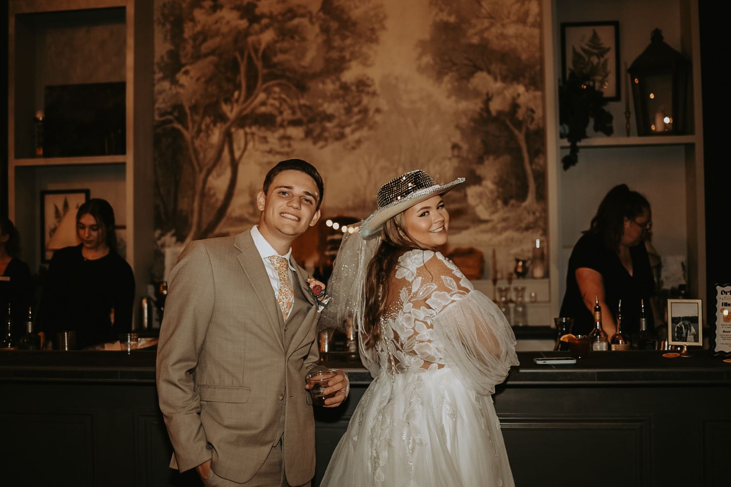 Wedding celebration in a dimly lit venue with vintage decor and warm ambiance.