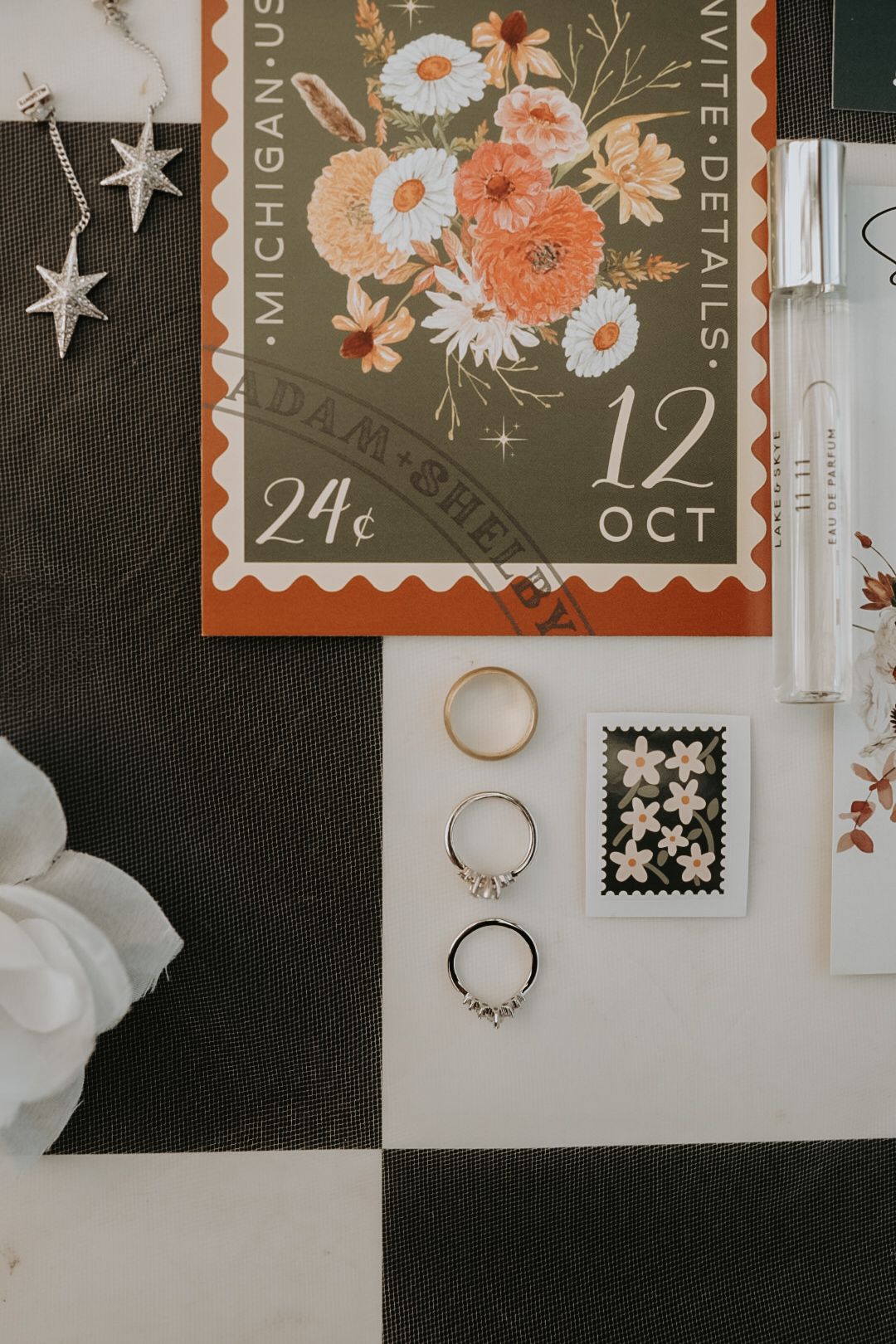 Wedding rings displayed on vintage postage stamps with floral designs.