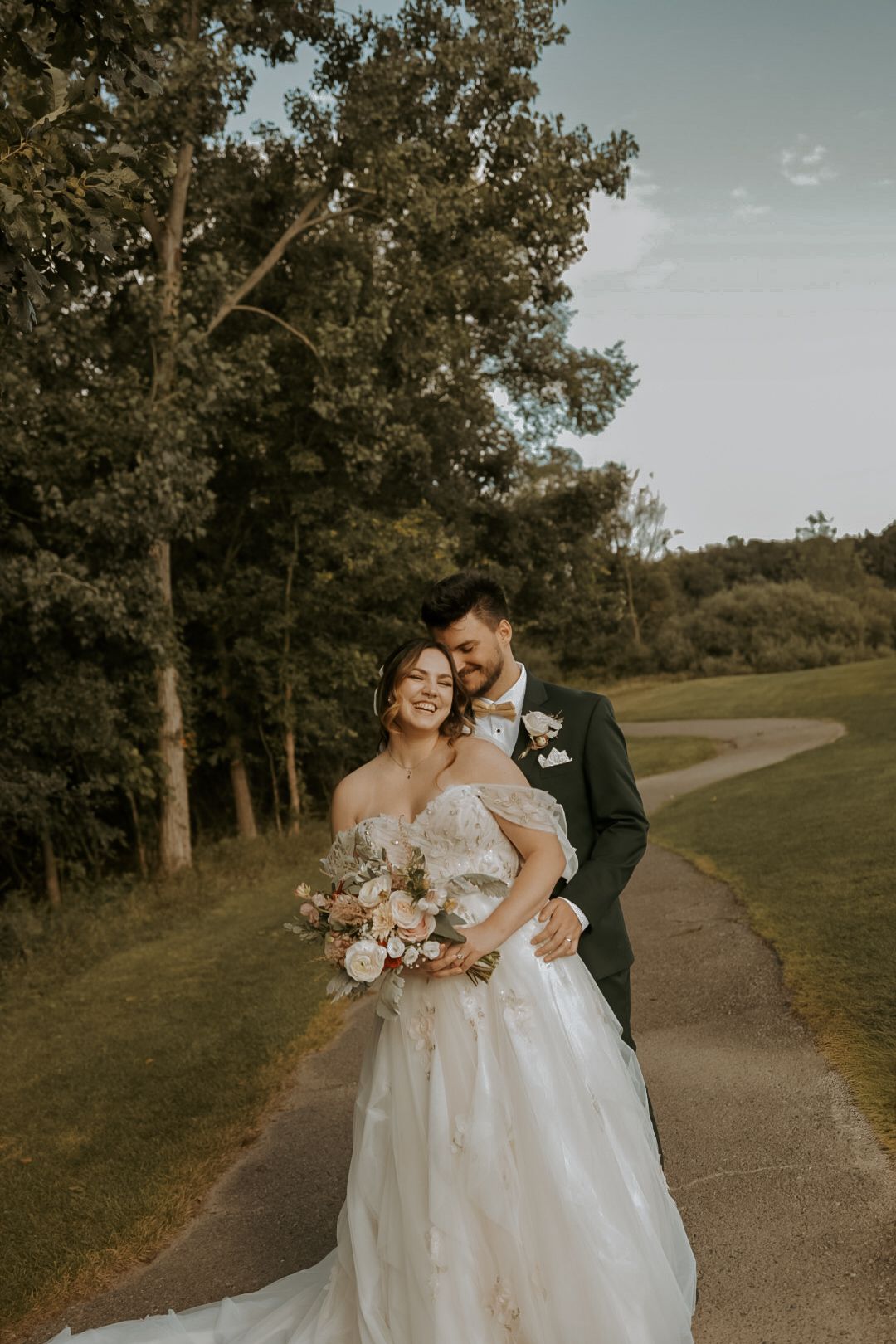 Michigan wedding photographer capturing a candid bride and groom outdoors in natural light