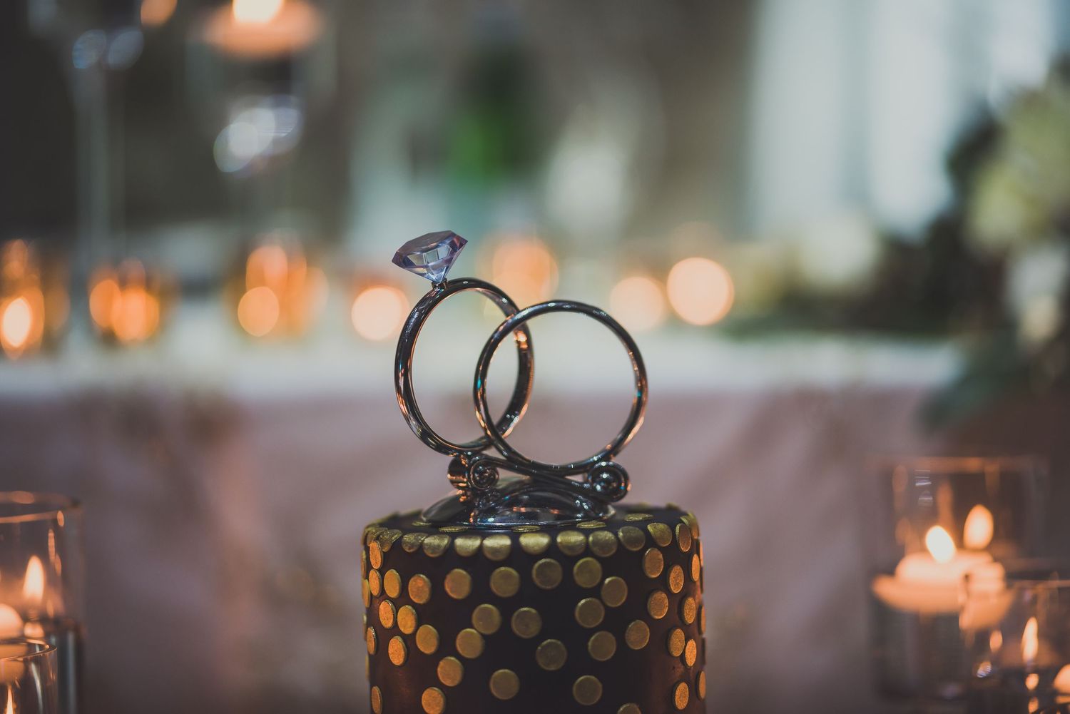Elegant table settings with glowing candles and decorative elements for a wedding reception.