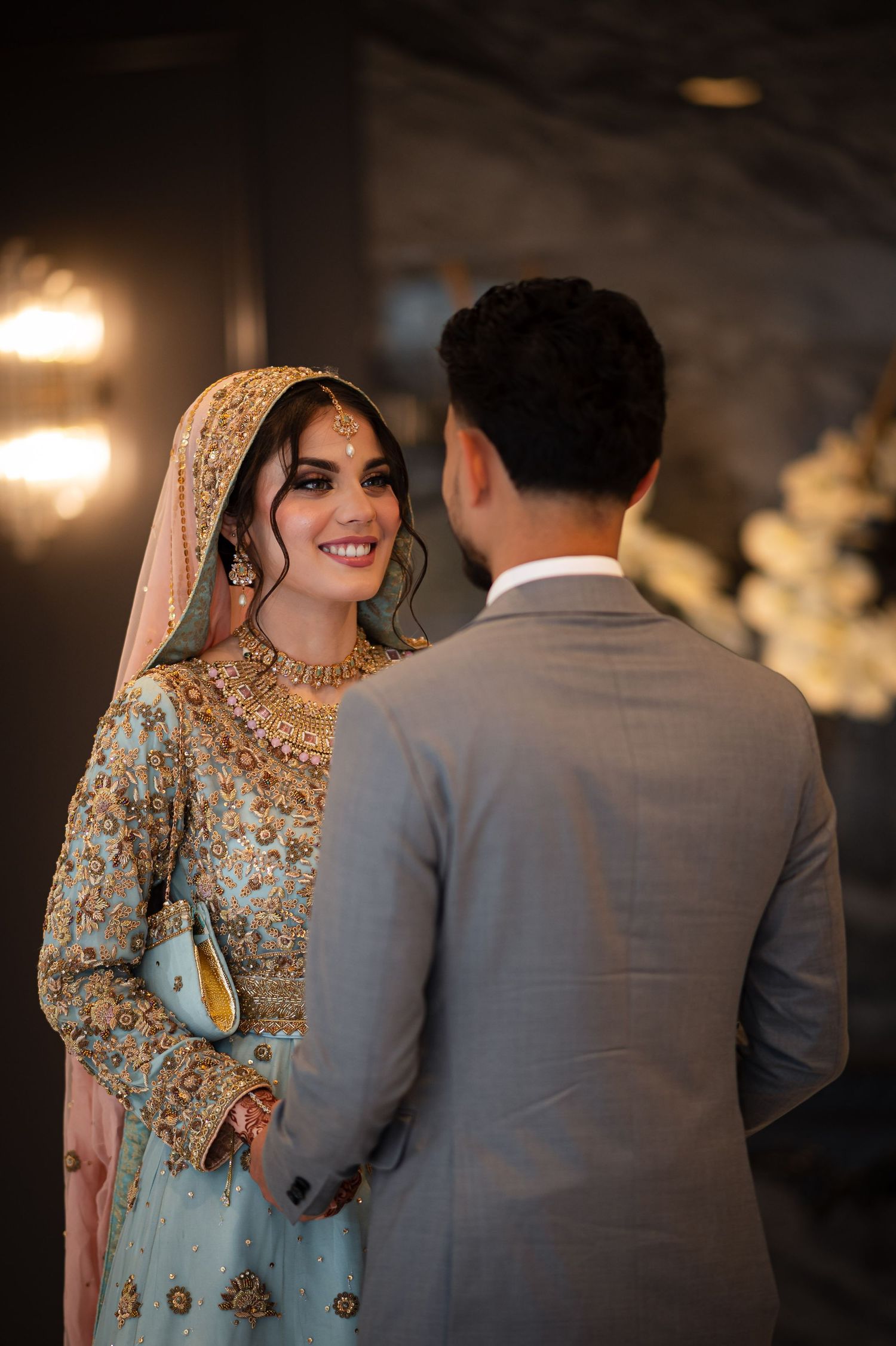 Couple in traditional South Asian wedding attire sharing intimate moments in a series of romantic poses.