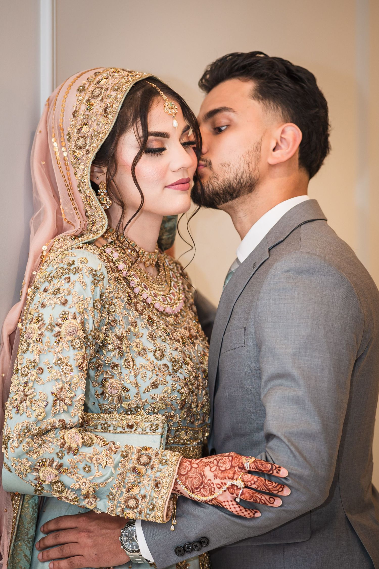 Romantic wedding portraits showing tender moments between newlyweds in traditional South Asian attire.