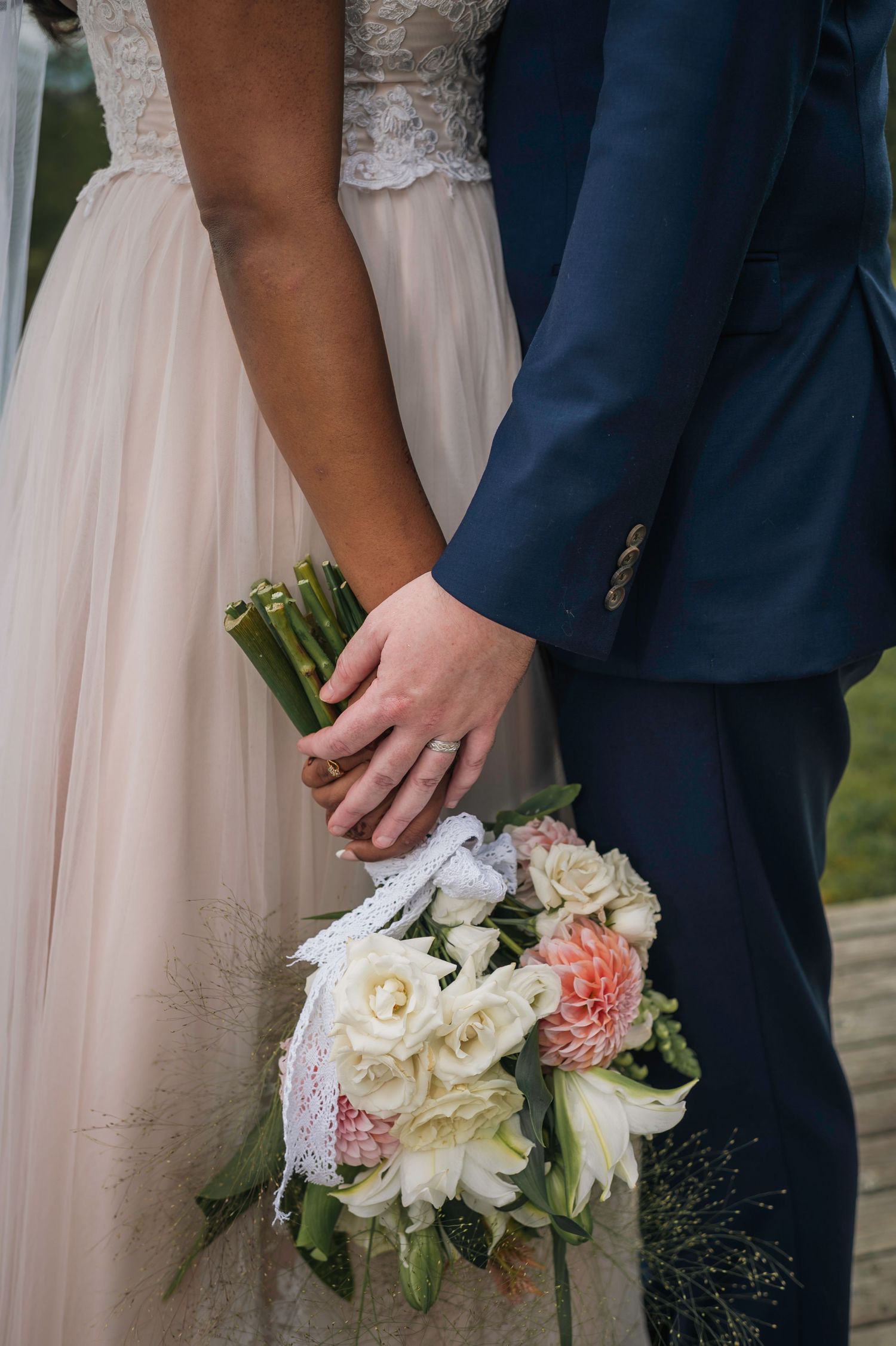 Three cropped wedding photos show hands holding elegant bouquets of white and pink roses against formal attire.