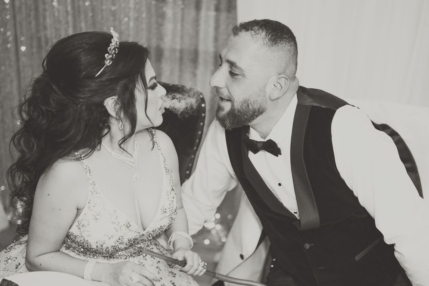 A black and white photo collage shows intimate moments of a couple kissing and embracing at their wedding celebration.