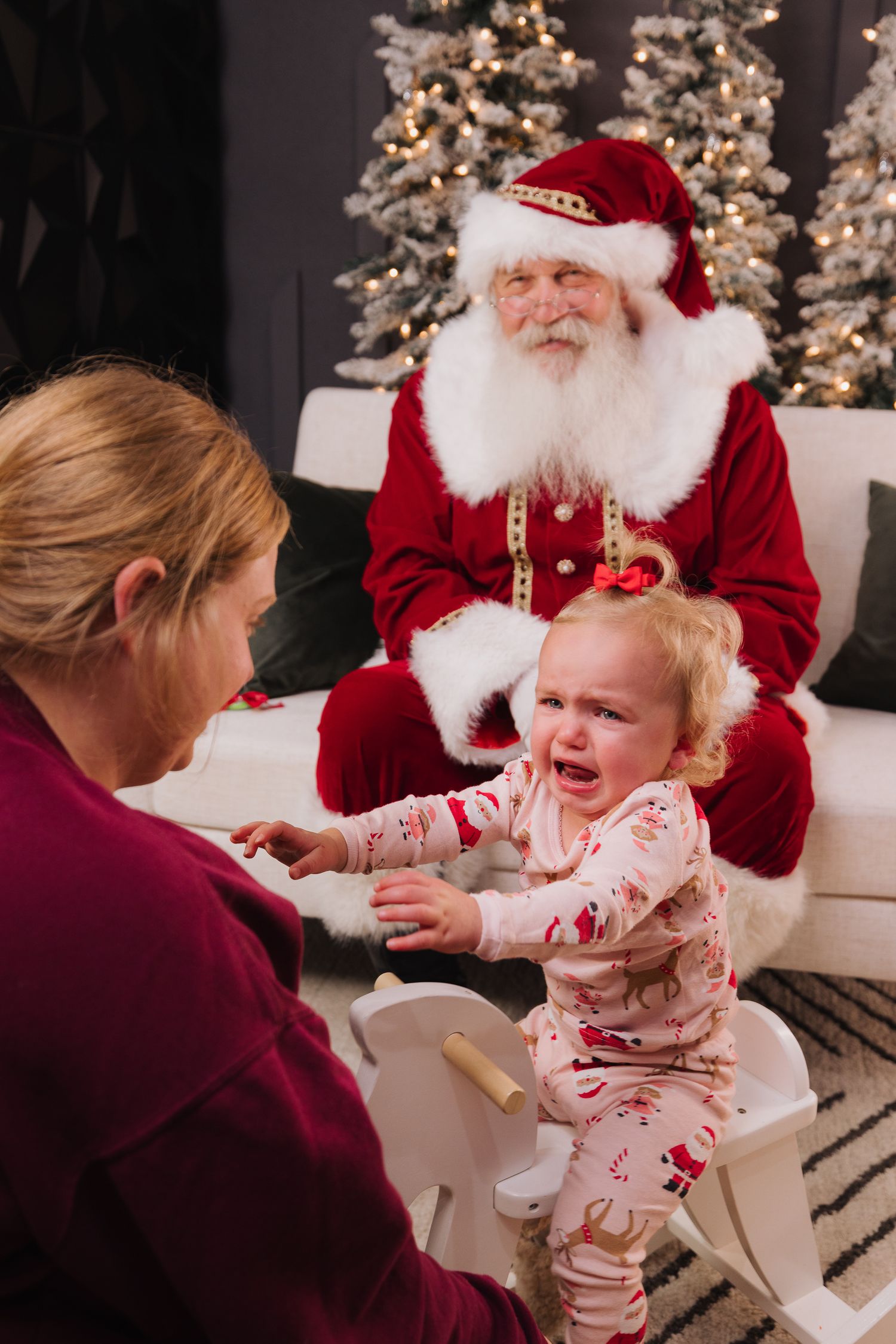 Holiday scene with crying baby and festive decorations.