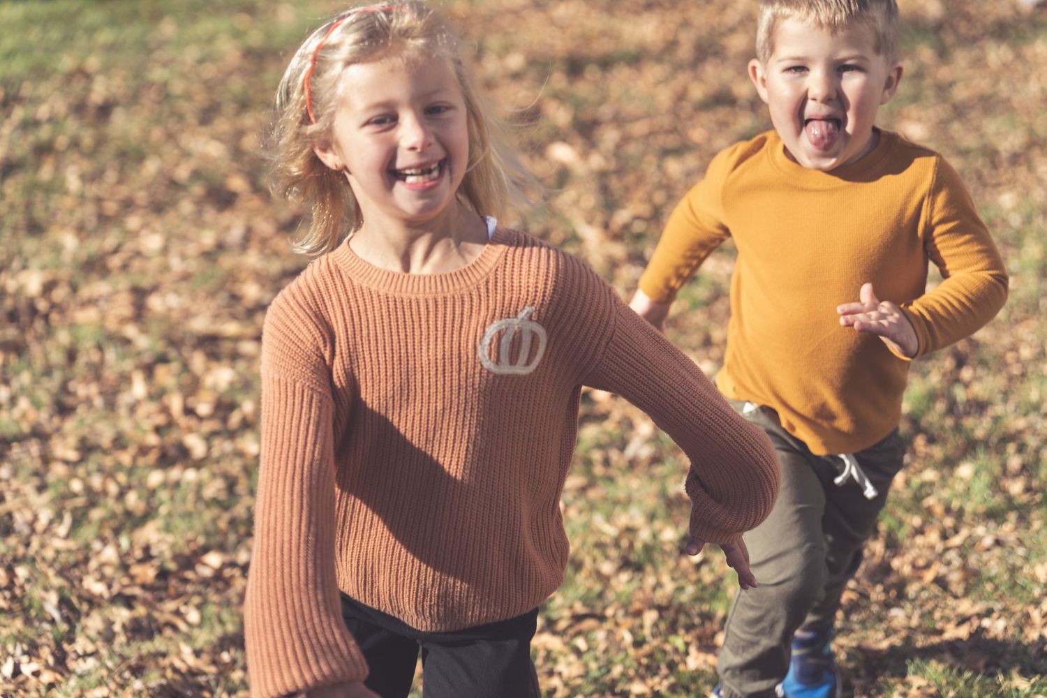 Energetic outdoor portraits with coordinated fall-colored sweaters.