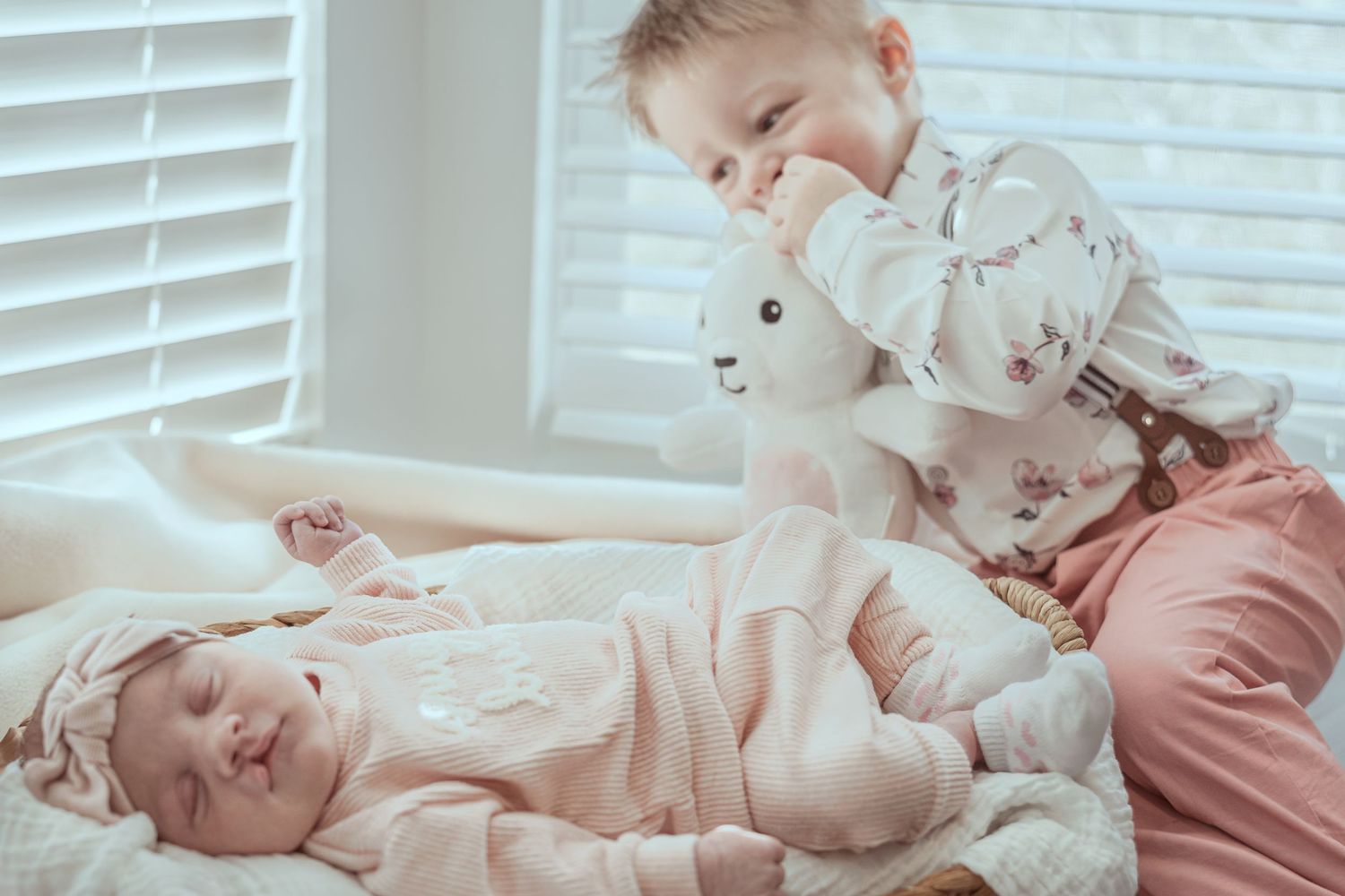 A series of five connected images showing a baby lying on a white bed in various sleeping and resting positions.