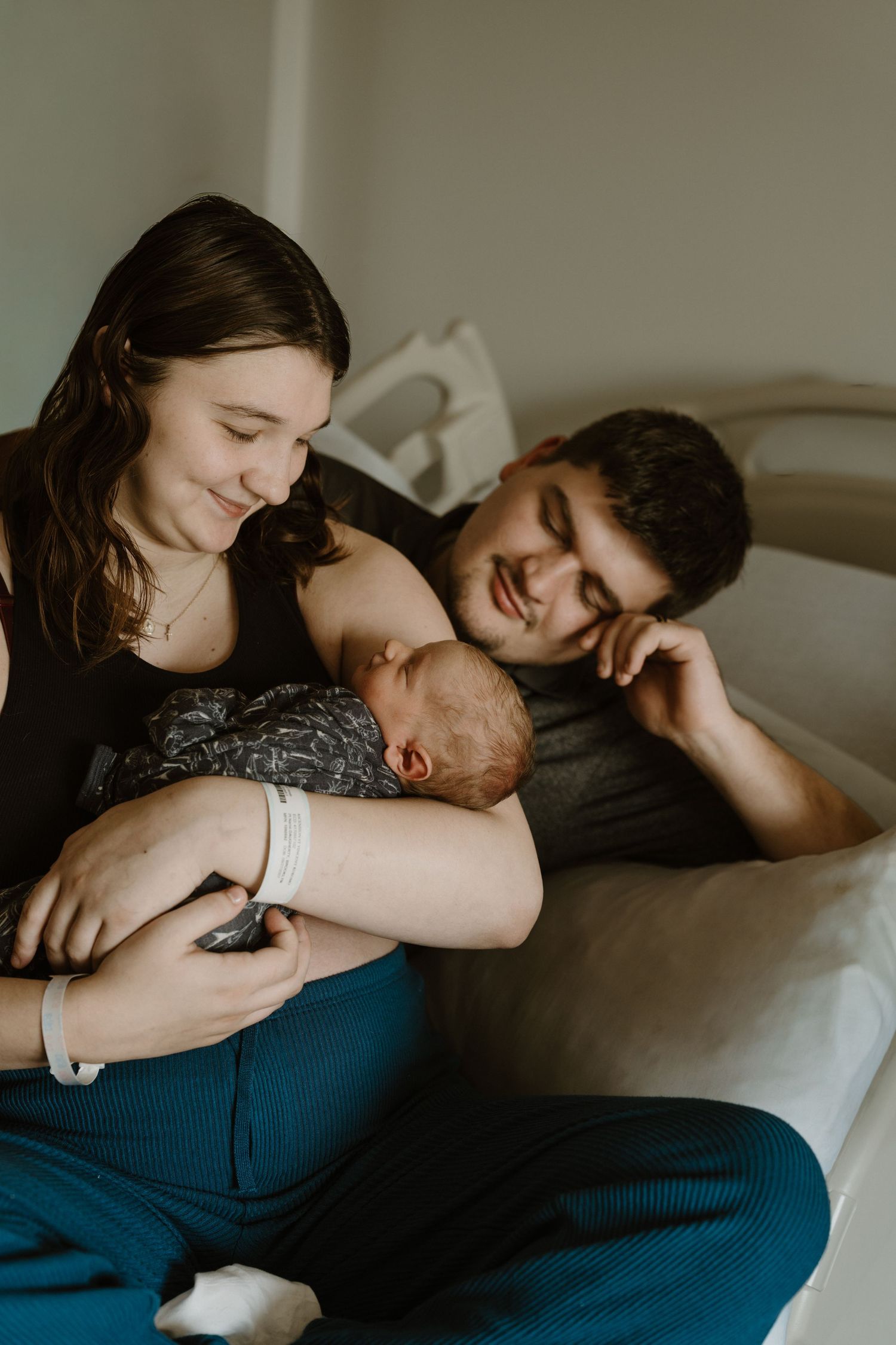 Fresh 48 hospital newborn photography session in North Central Indiana featuring new parents smiling with their new baby.