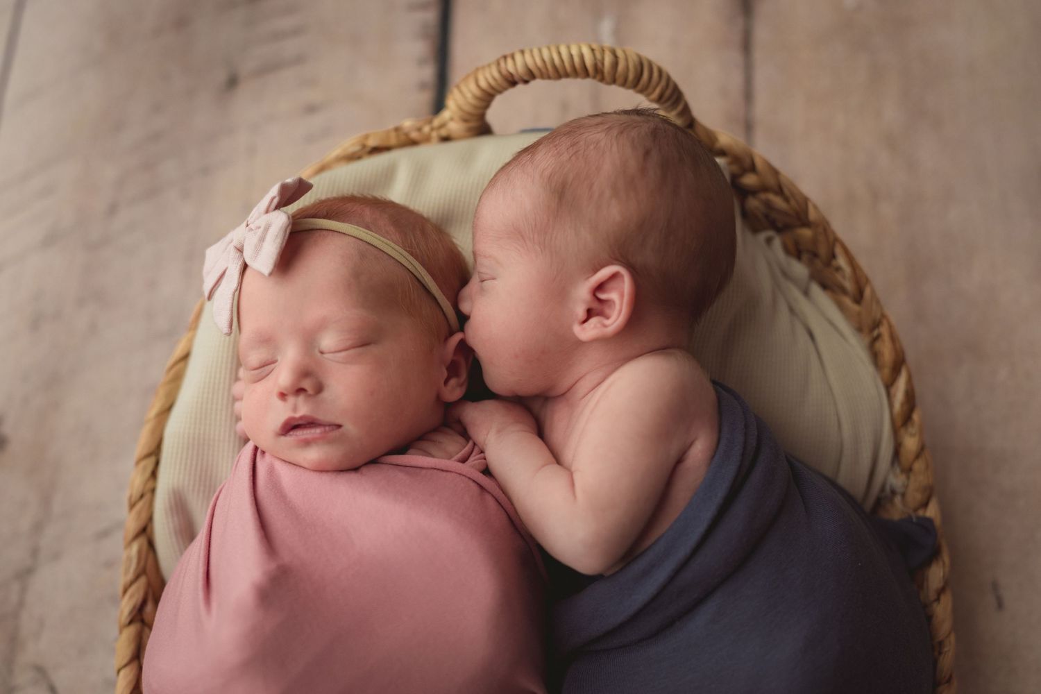 Newborn twins swaddled in pink and blue wraps during in-home newborn session with Bushel & a Peck Photography North Central IN