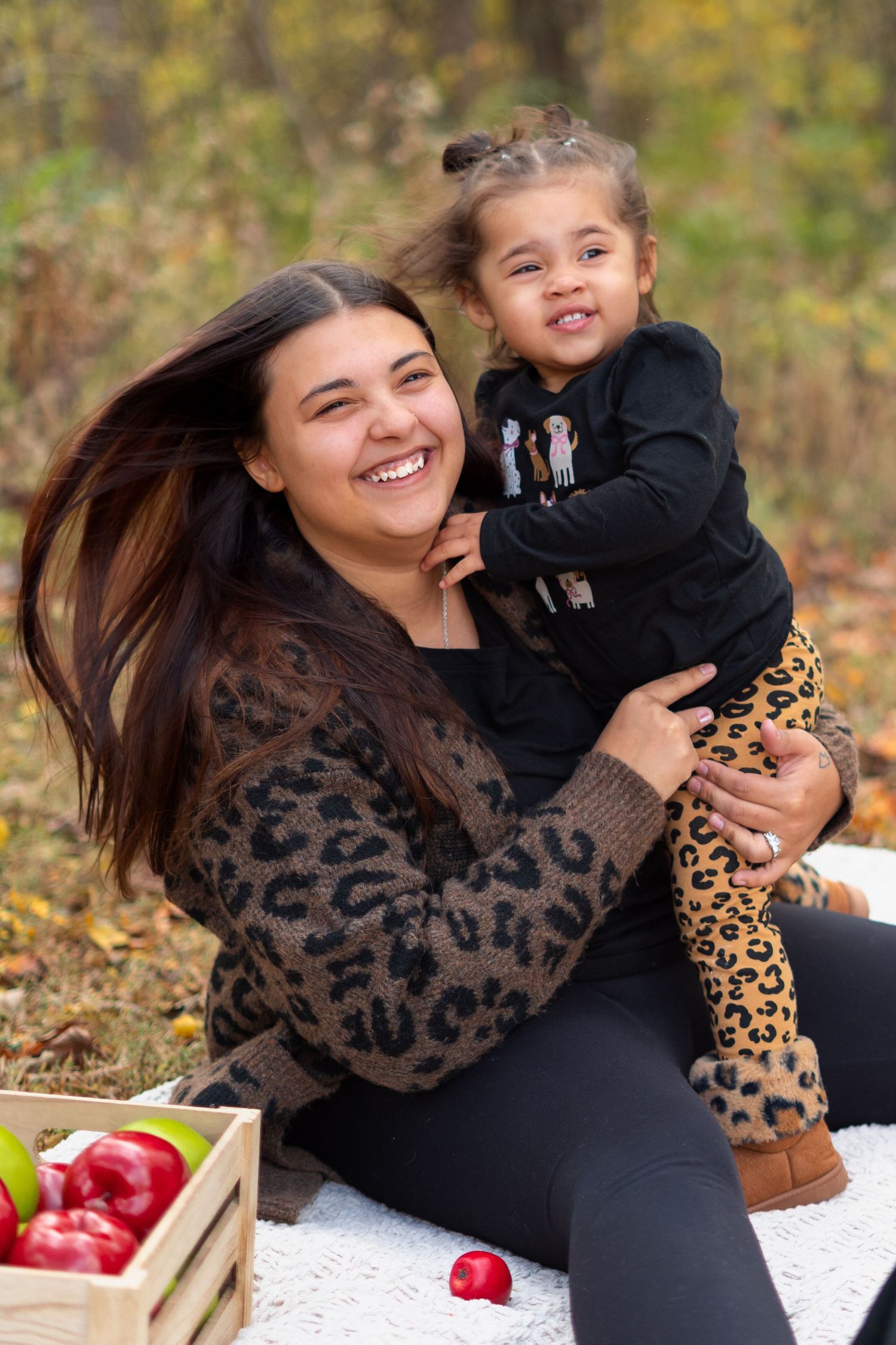 Candid moments of family bonding with leopard print accents during autumn photoshoot.
