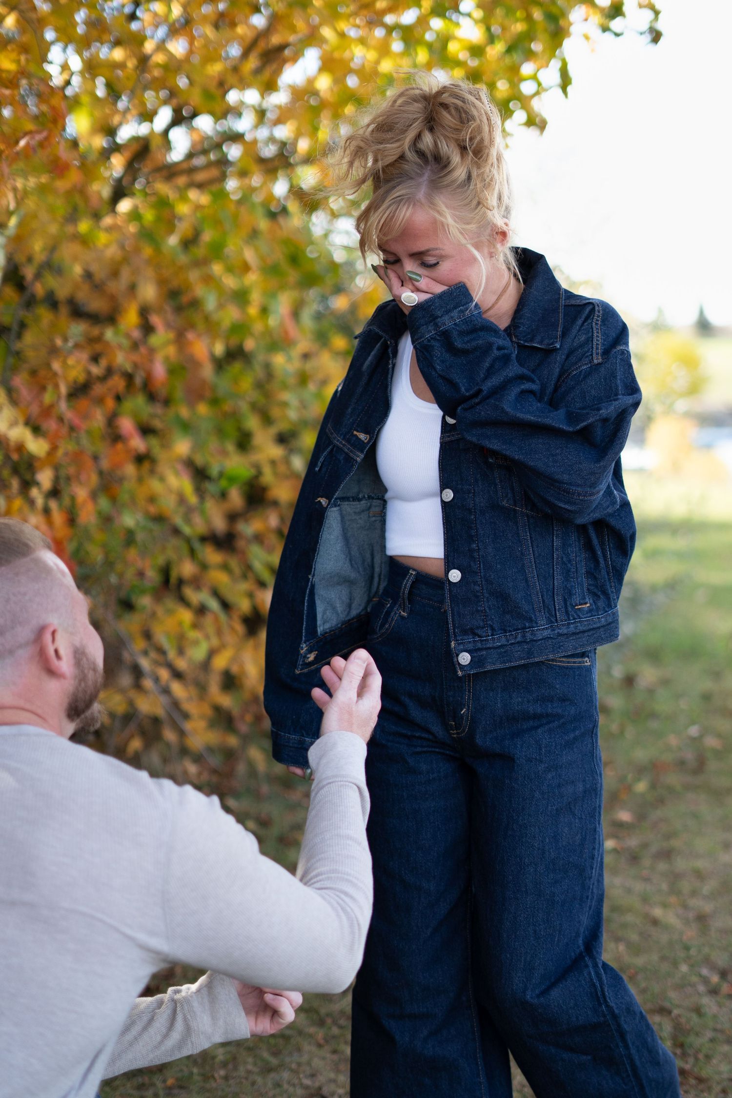 Emotional engagement moment photographed in a park during autumn season.