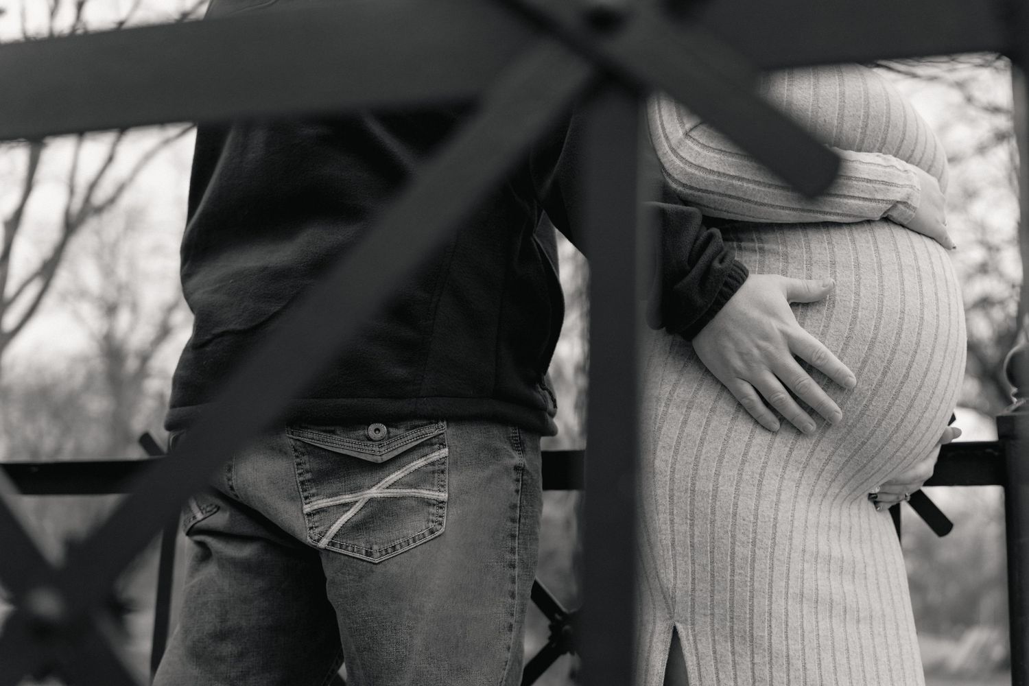 Black and white candid shots of a couple walking together on a path.