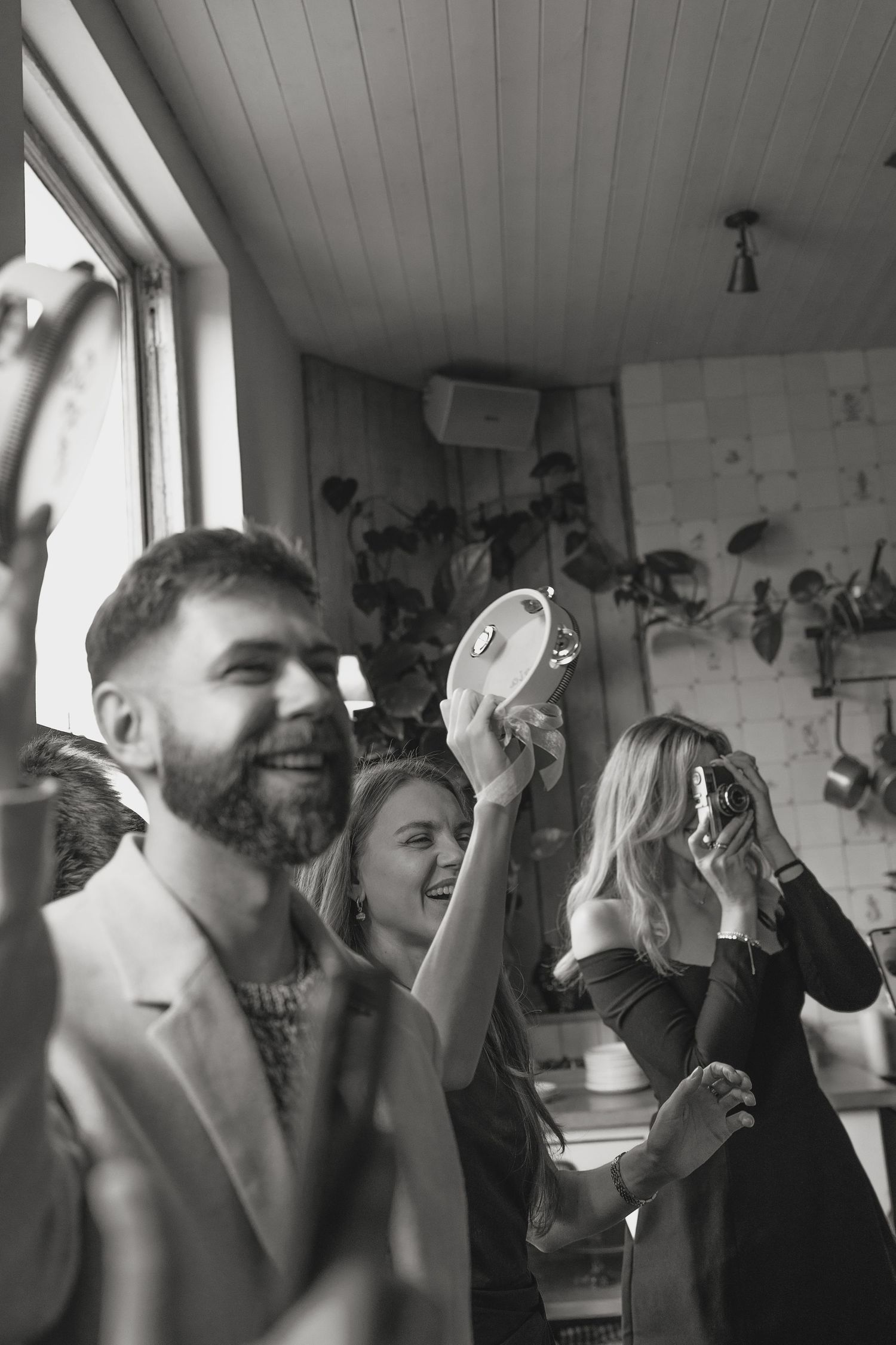 A lively group of people cheering and celebrating in an indoor space.
