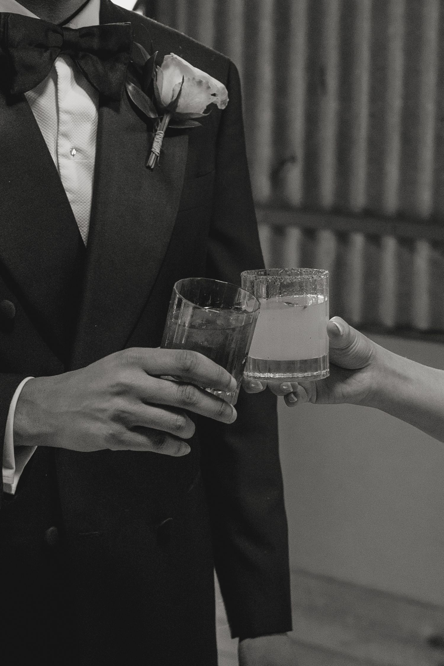 Guests in formal attire toasting with champagne glasses at an elegant event.