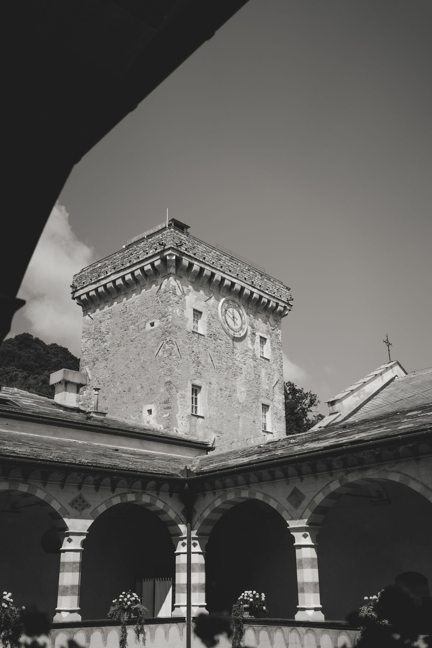 Black and white architectural photo of a historic stone building with arched columns.