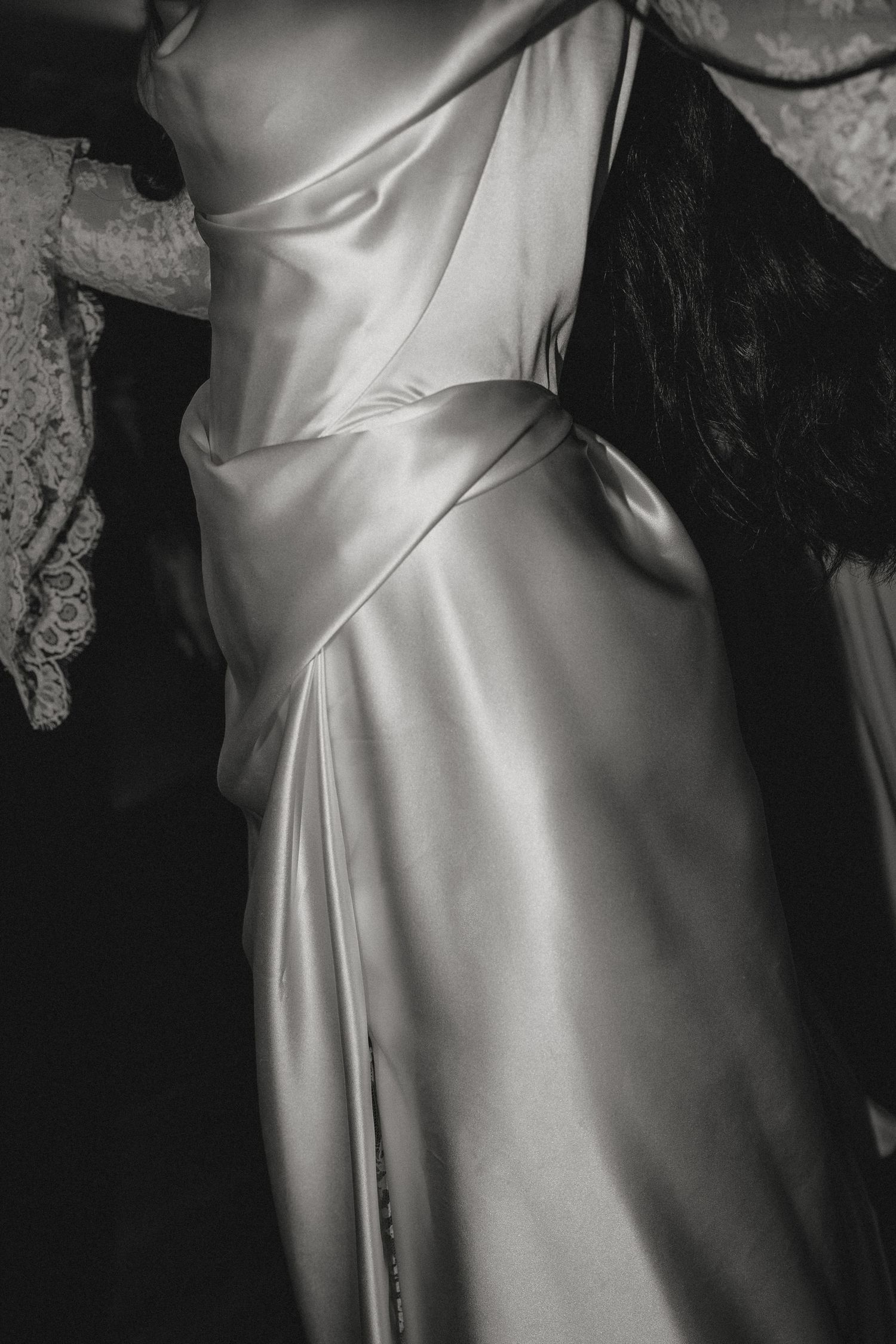 Close-up detail of an elegant white satin wedding dress.