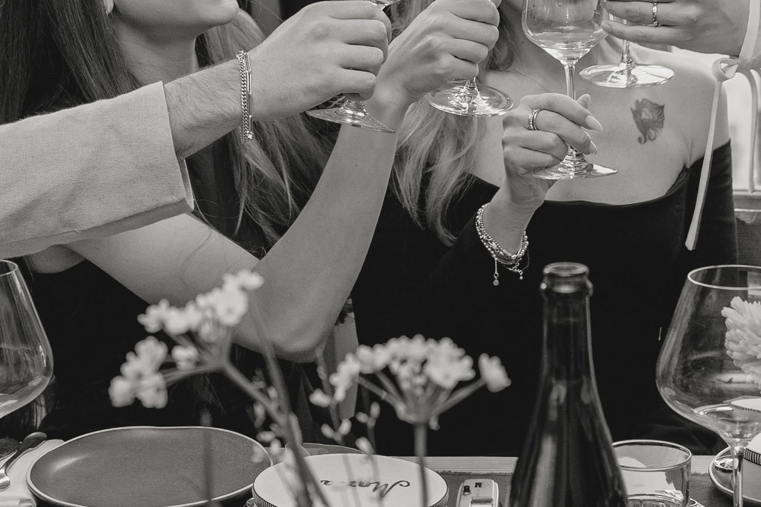 Wine glasses and table settings at an intimate dinner party.