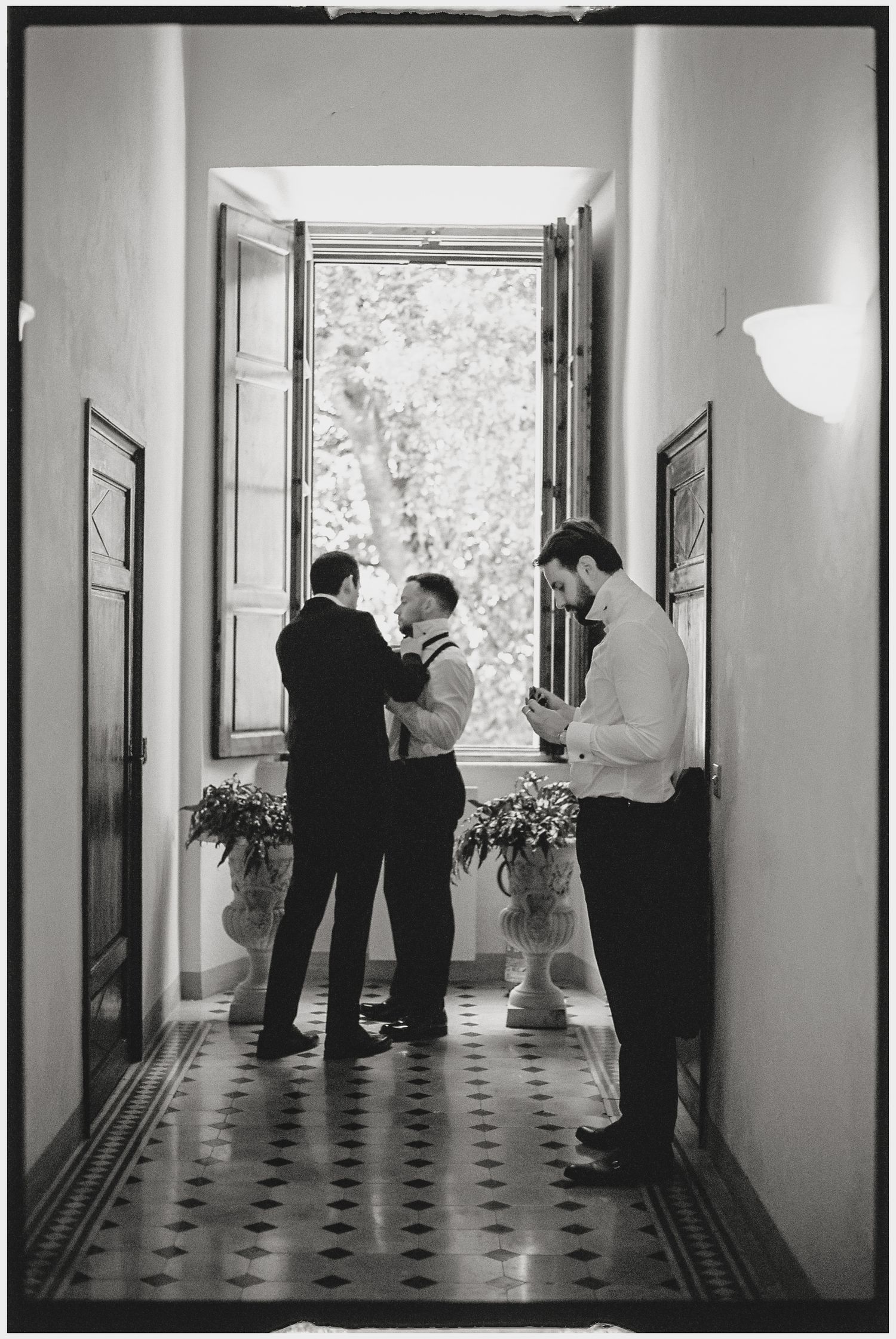 Black and white photos show elegant interior hallway with checkered floor and window light.