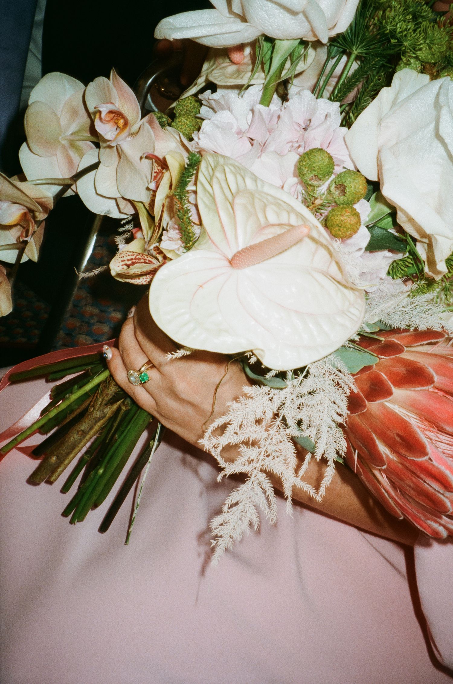 Elegant wedding bouquet with white orchids, pink flowers and delicate greenery.