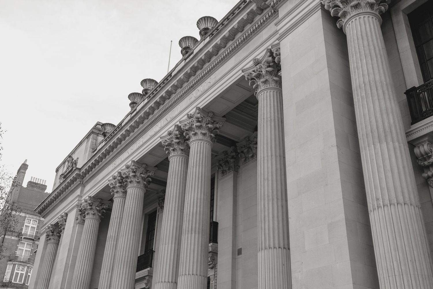 Classical architecture with towering white columns photographed from a low angle.