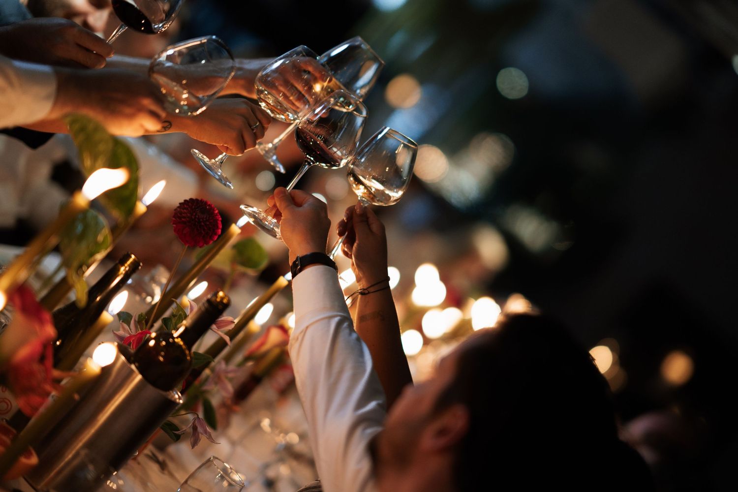 Sparkling champagne glasses clink together in celebration at an elegant event.