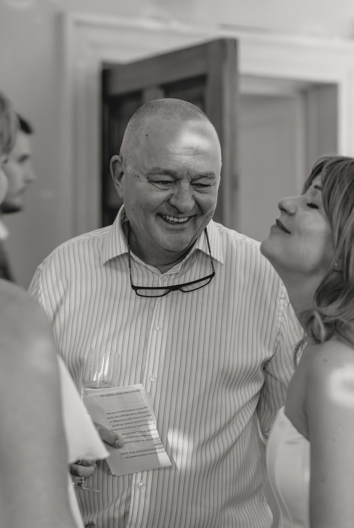 A series of black and white photos showing joyful interactions between people at a social gathering.